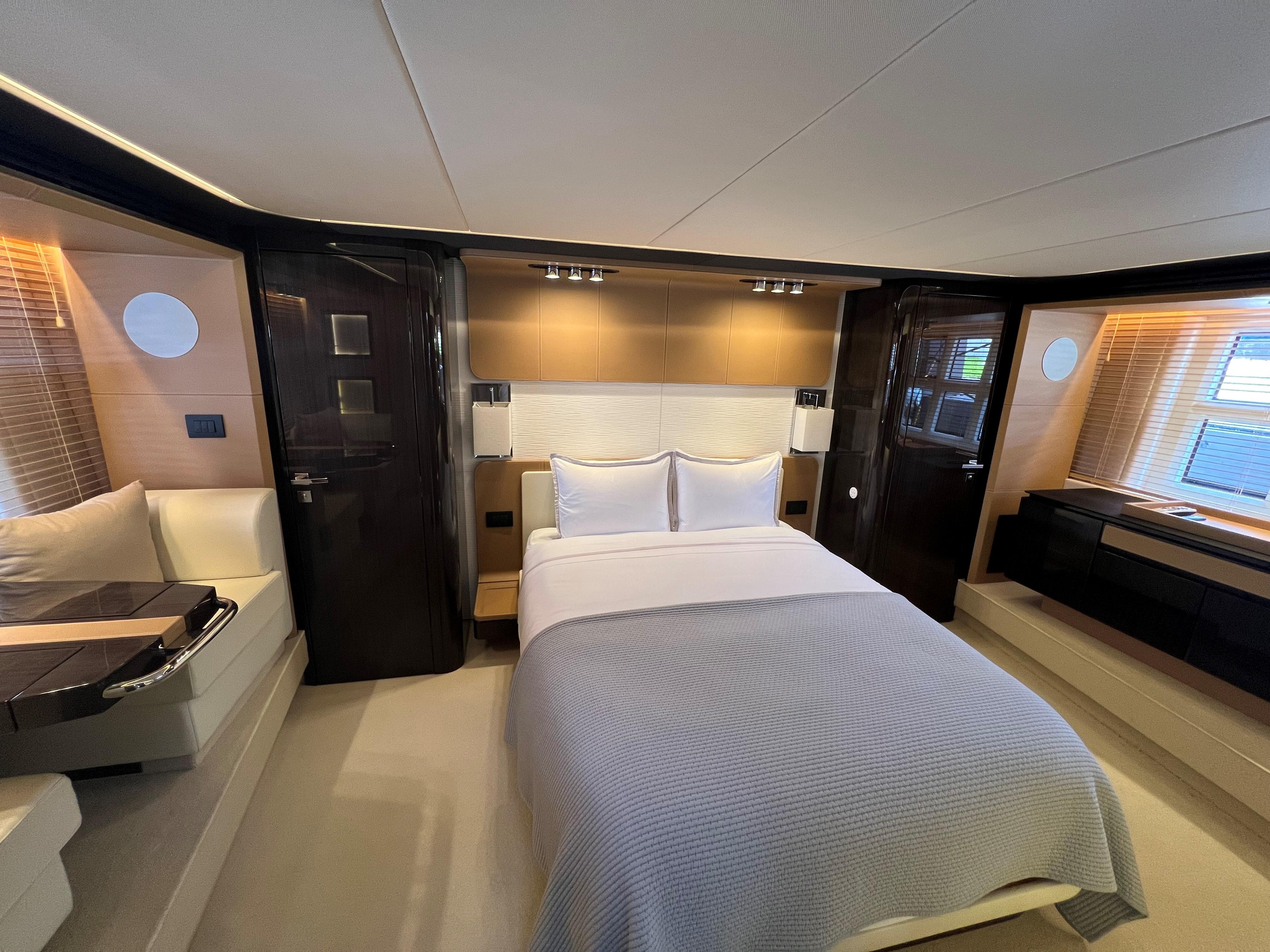 Luxurious bedroom interior of 2019 Azimut 77S yacht with modern design.