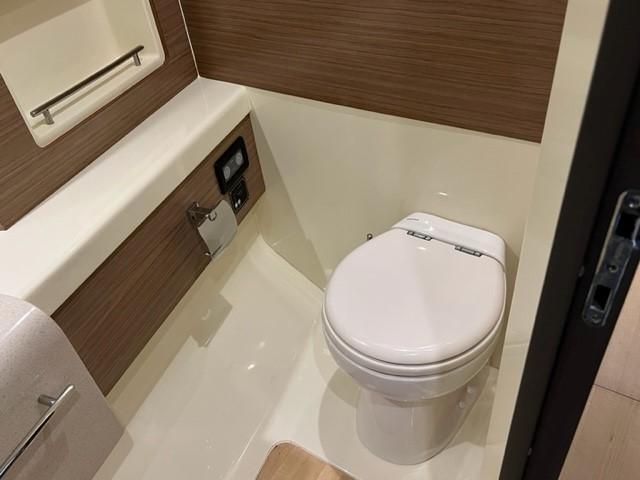 2018 Chris-Craft Launch 38 boat bathroom with modern fixtures and wood accents.