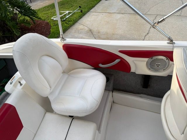 Interior of a 2012 Bayliner 184 SF with white and red seating.