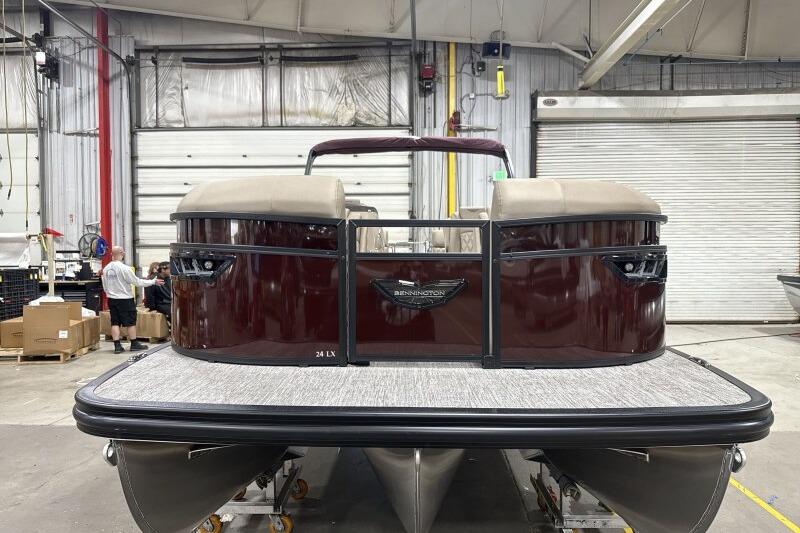 2026 Bennington 24 LXS Quadbench pontoon boat in a warehouse setting.
