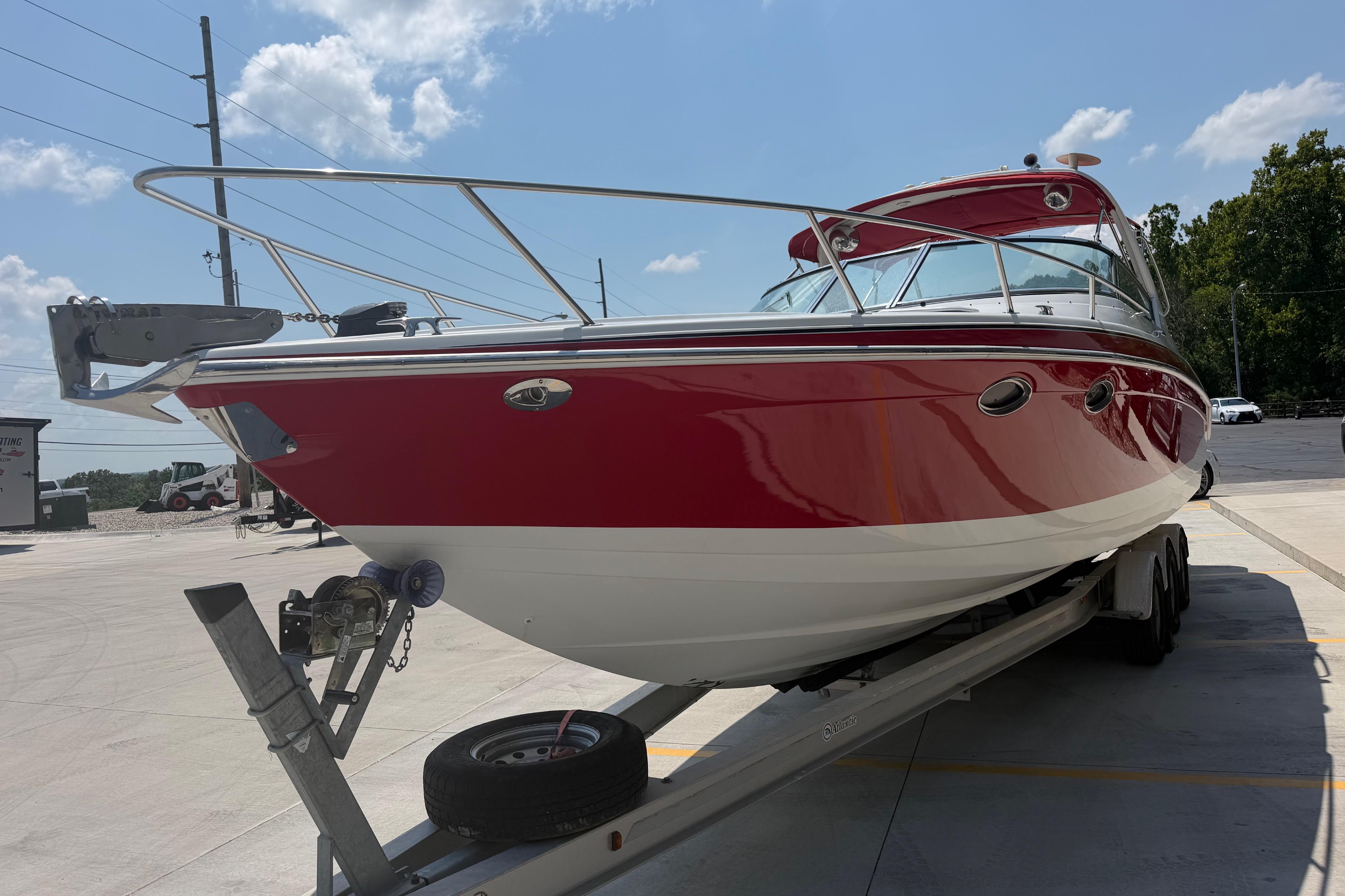 2006 Formula 330 Sun Sport boat on trailer under clear sky.