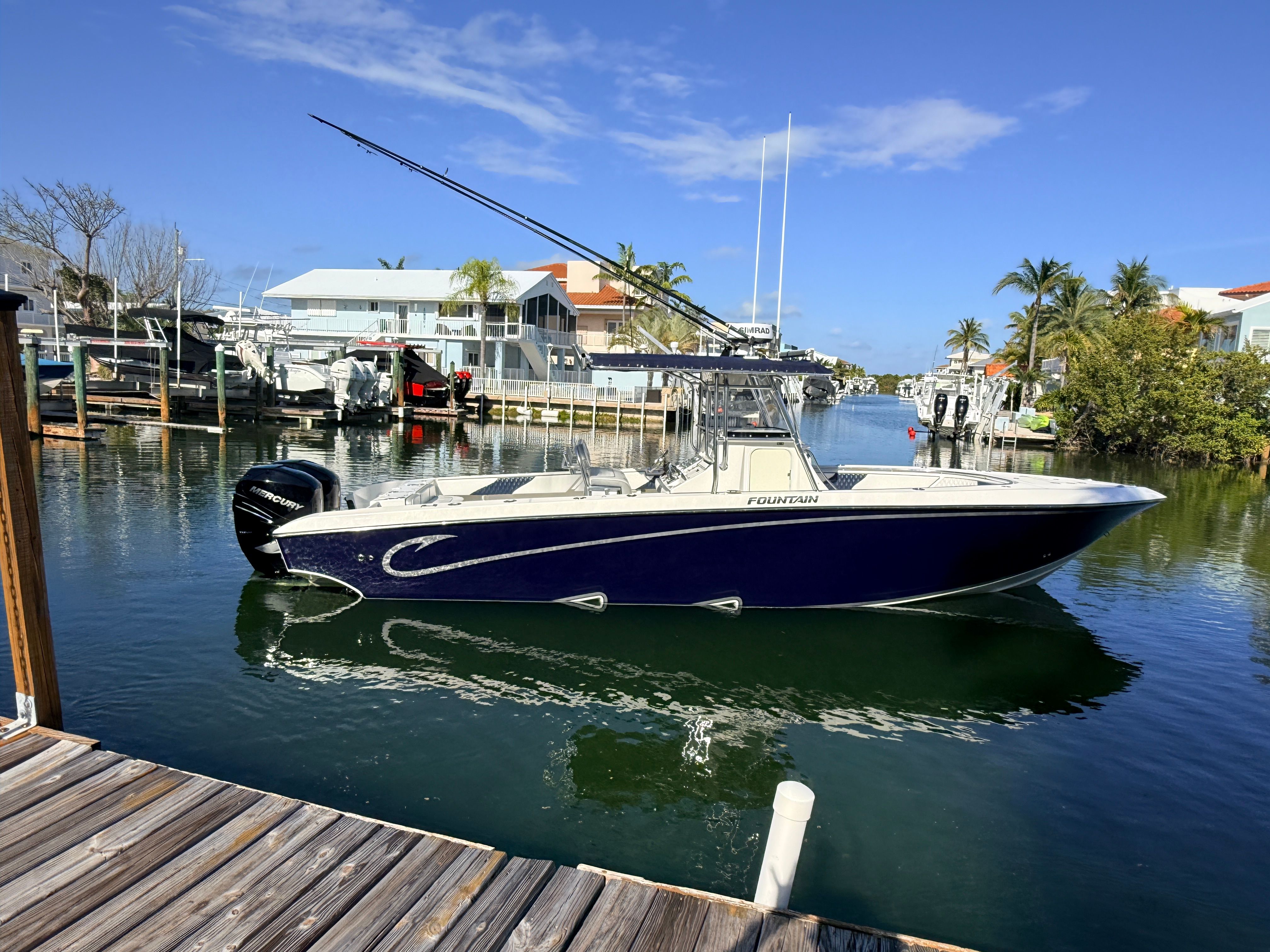 2007 Fountain 32 Center Console boat docked in harbor.