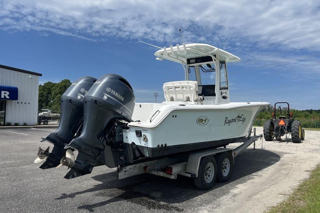 2021 Sea Hunt Gamefish 25 boat on trailer with dual Yamaha engines.