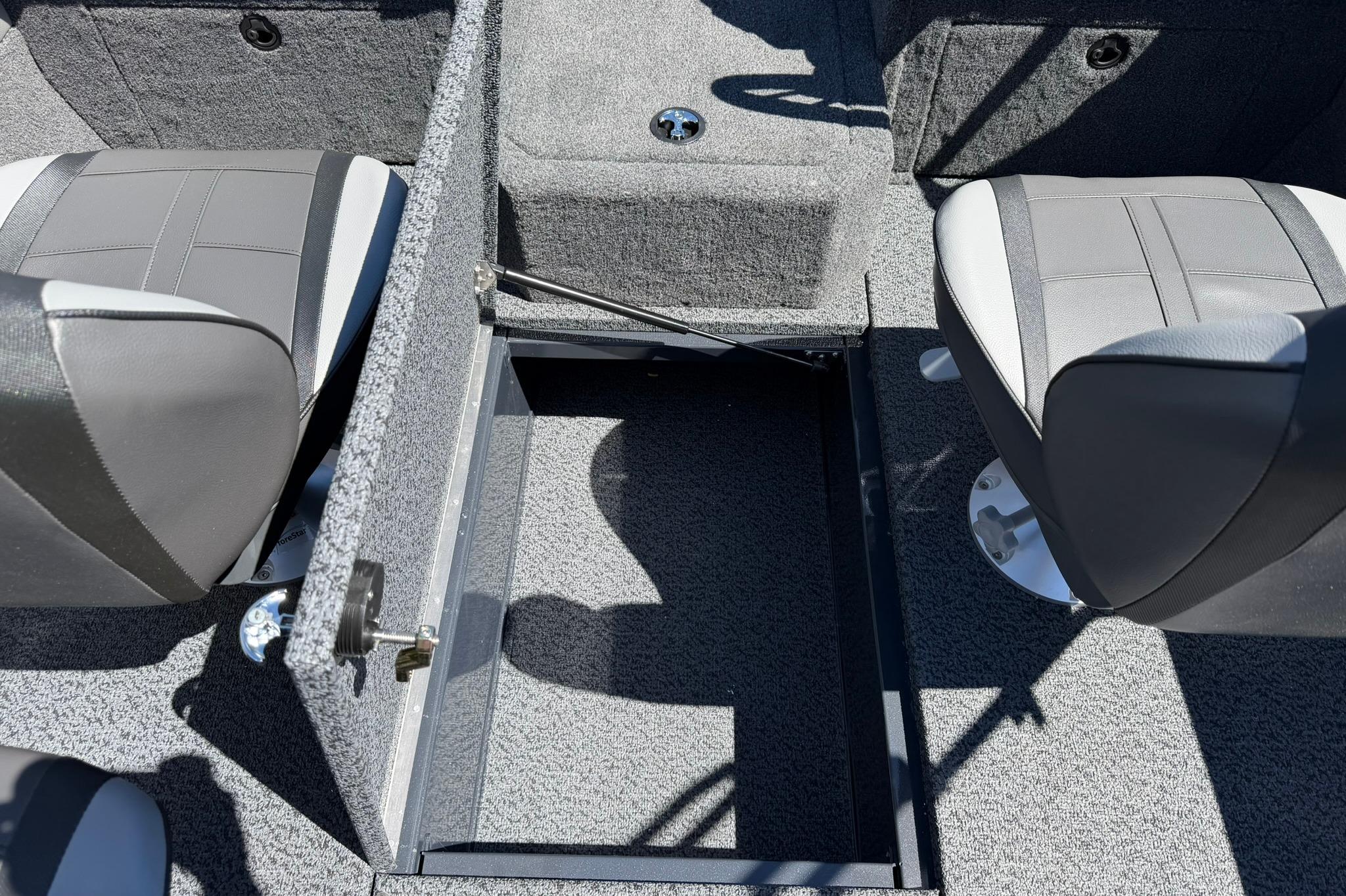 Interior of 2027 Lund 1775 Crossover XS boat showing seating and storage compartment.