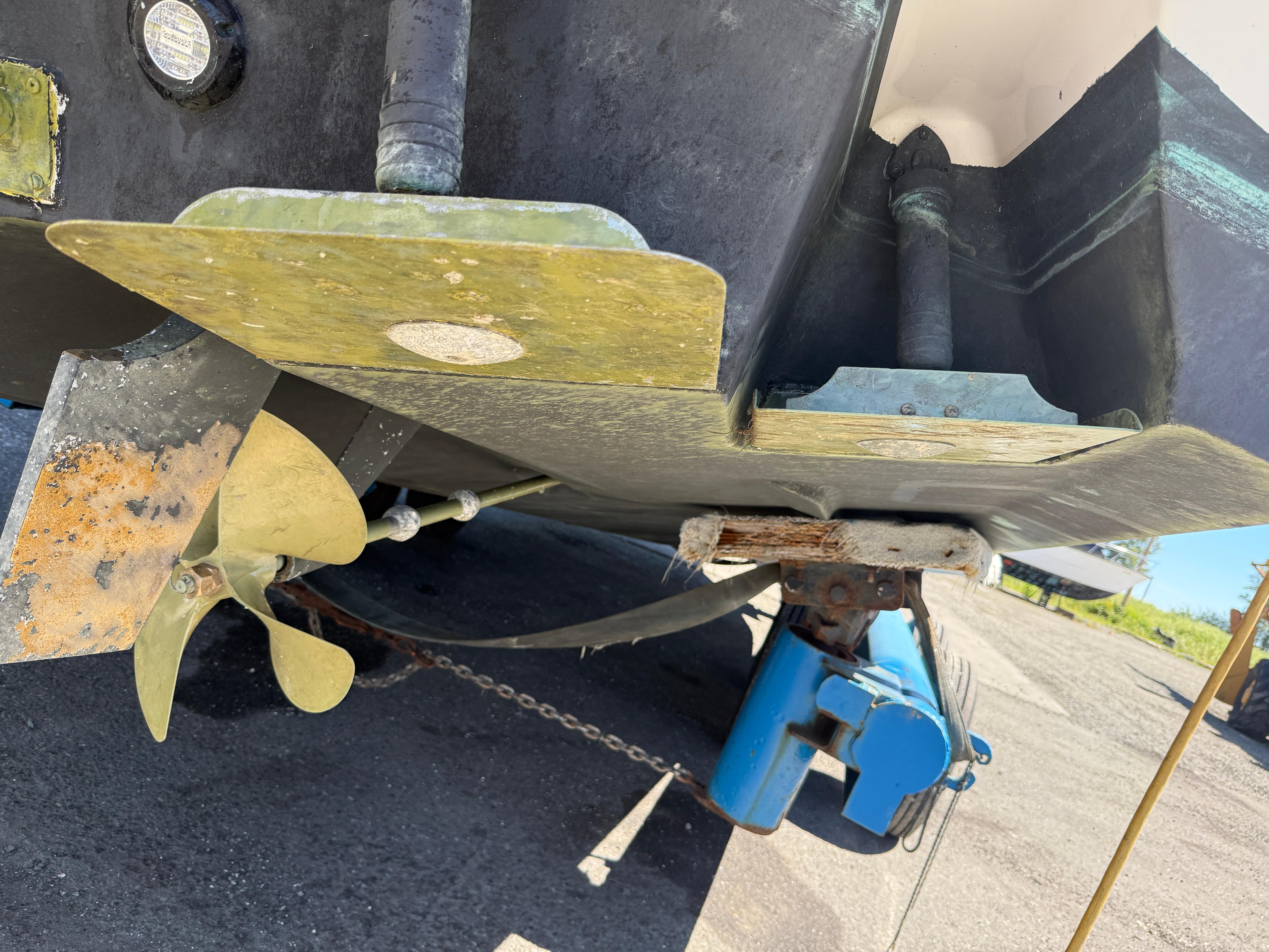2008 Four Winns V358 boat propeller and rudder detail on dry dock.
