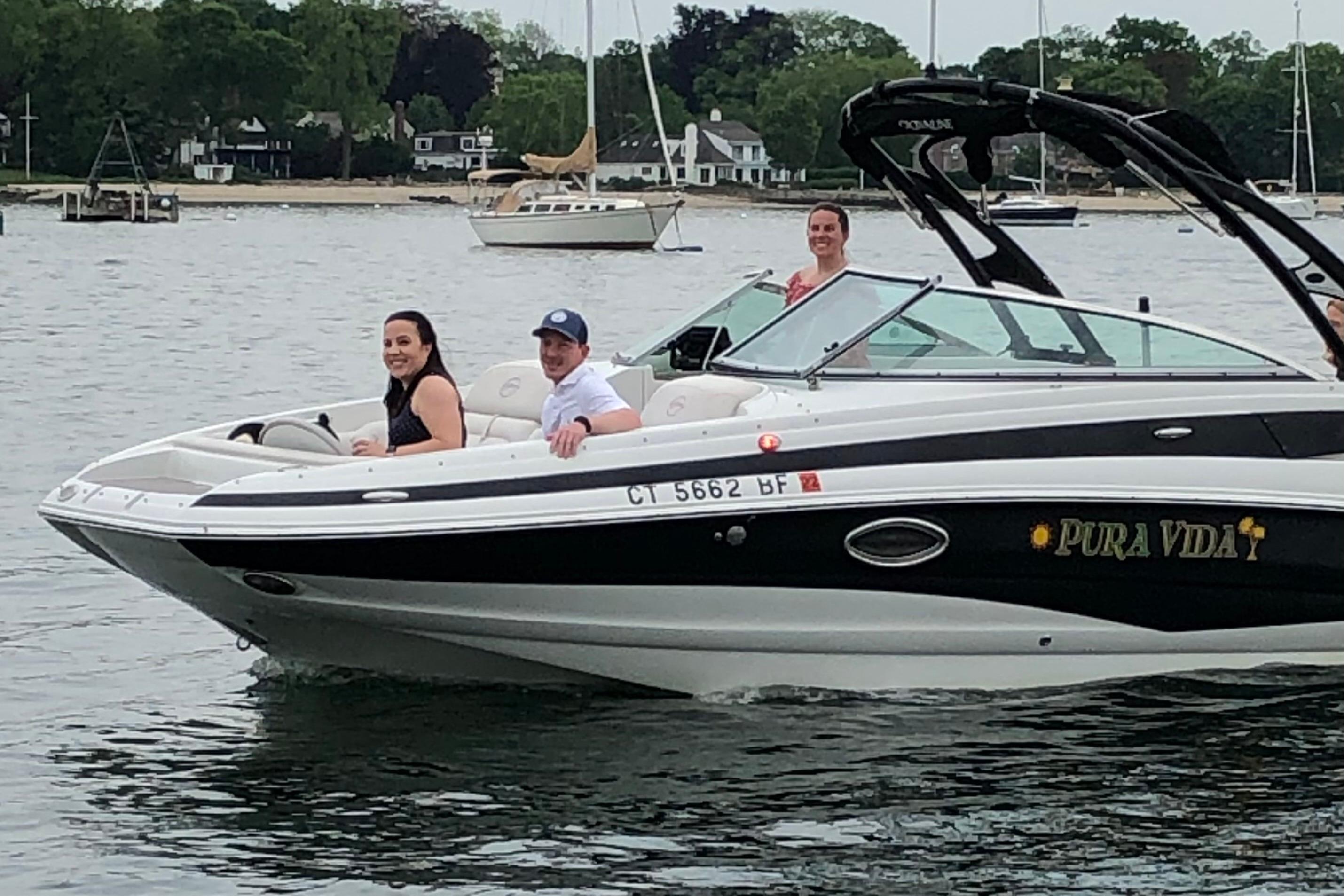 2013 Crownline Eclipse E4 boat with passengers on a calm lake.