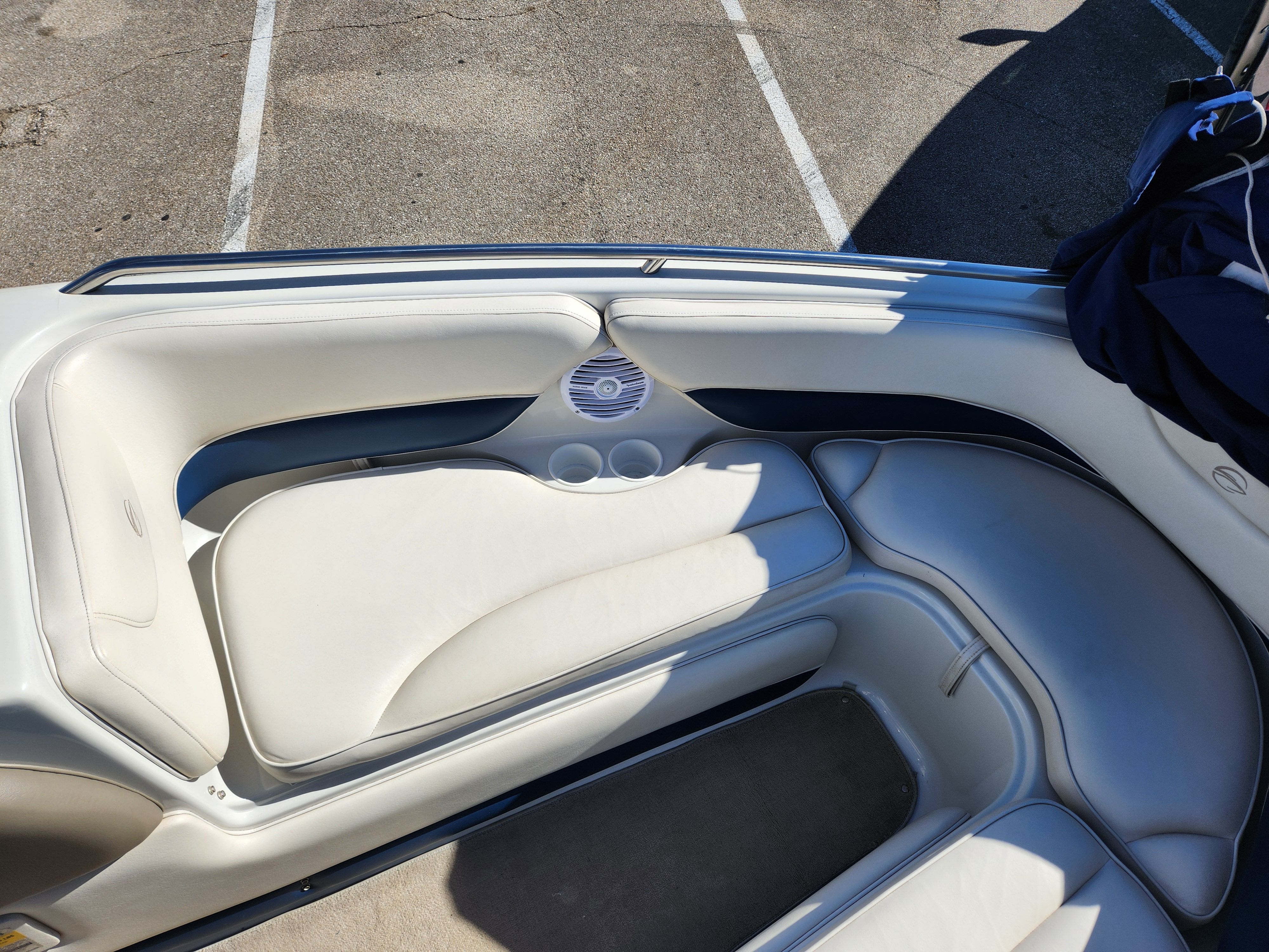 Interior of a 2003 Crownline 225 BR boat with white upholstery.