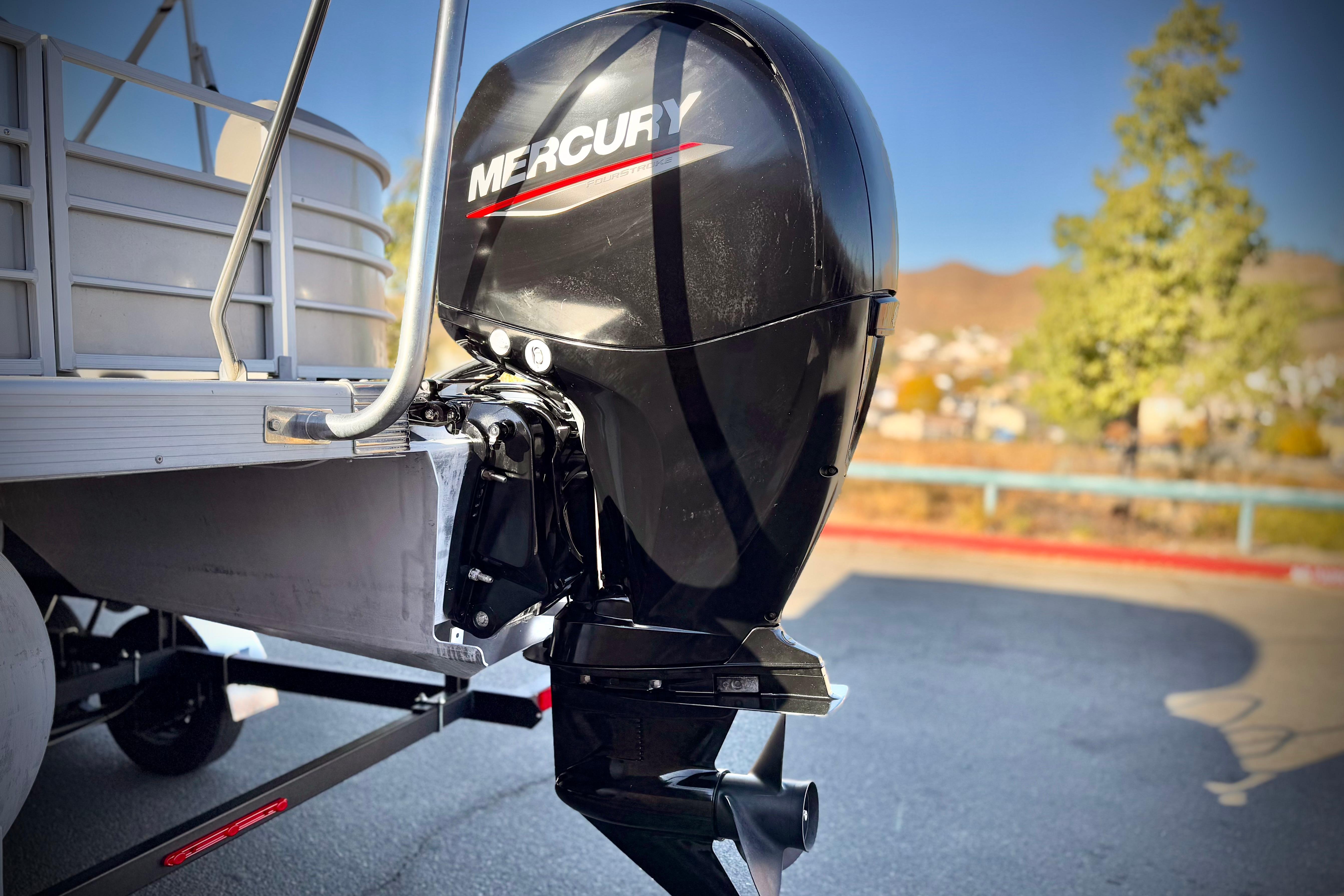 2021 Bennington 23LSR pontoon boat with Mercury outboard motor, parked outdoors.