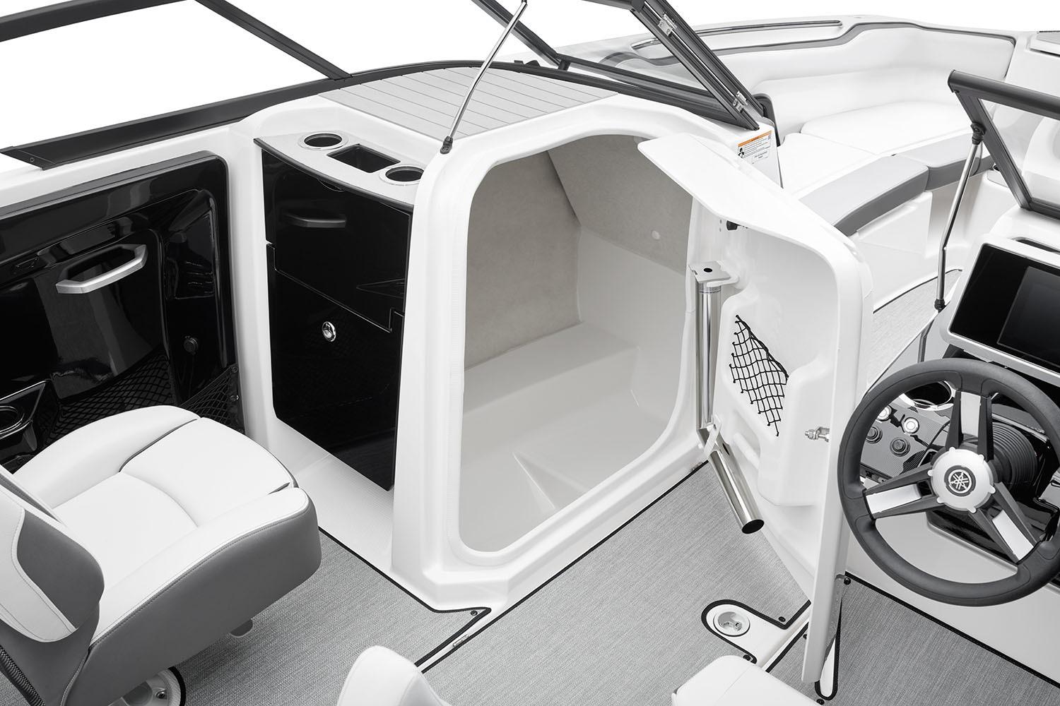 Manufacturer Provided Image: 2026 Yamaha Boats AR250 interior with helm, seating, and storage compartment.