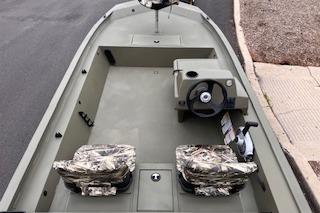 2026 Tracker Grizzly 1754 SC boat interior with camo seats and steering console.