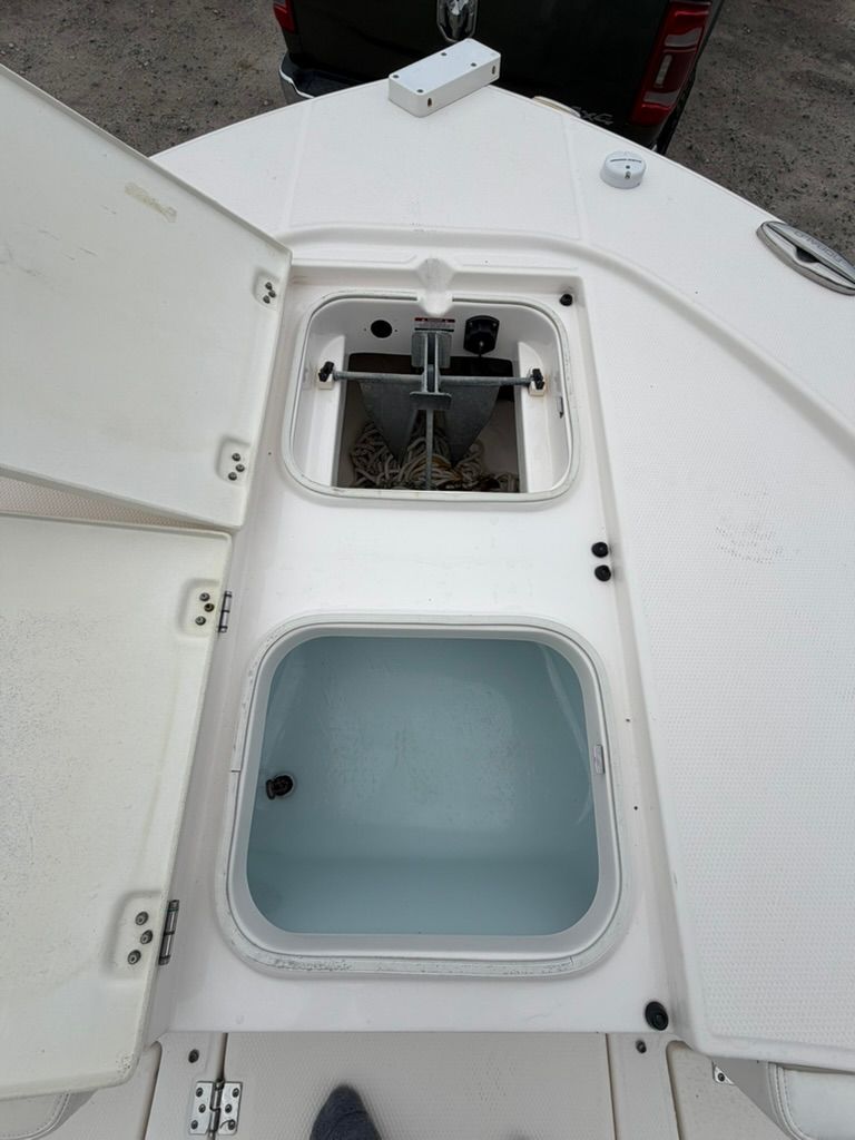 2018 Robalo 246 Cayman SD with open storage compartments on deck.