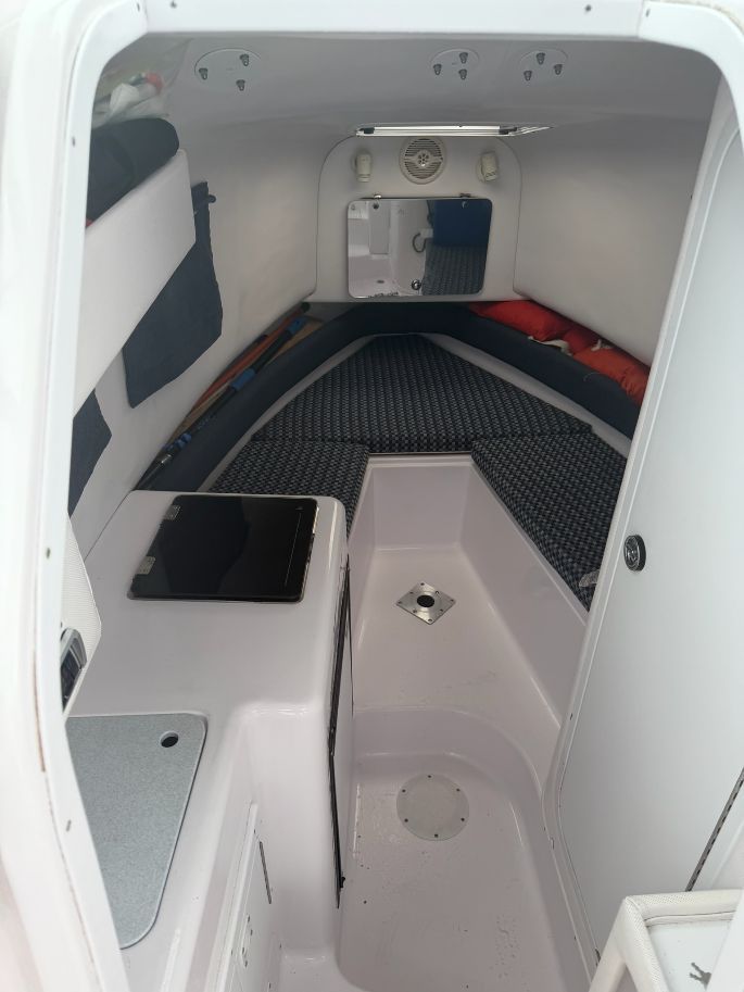 Interior of a 2003 Pro-Drive Walkaround with cushioned V-berth and storage space.