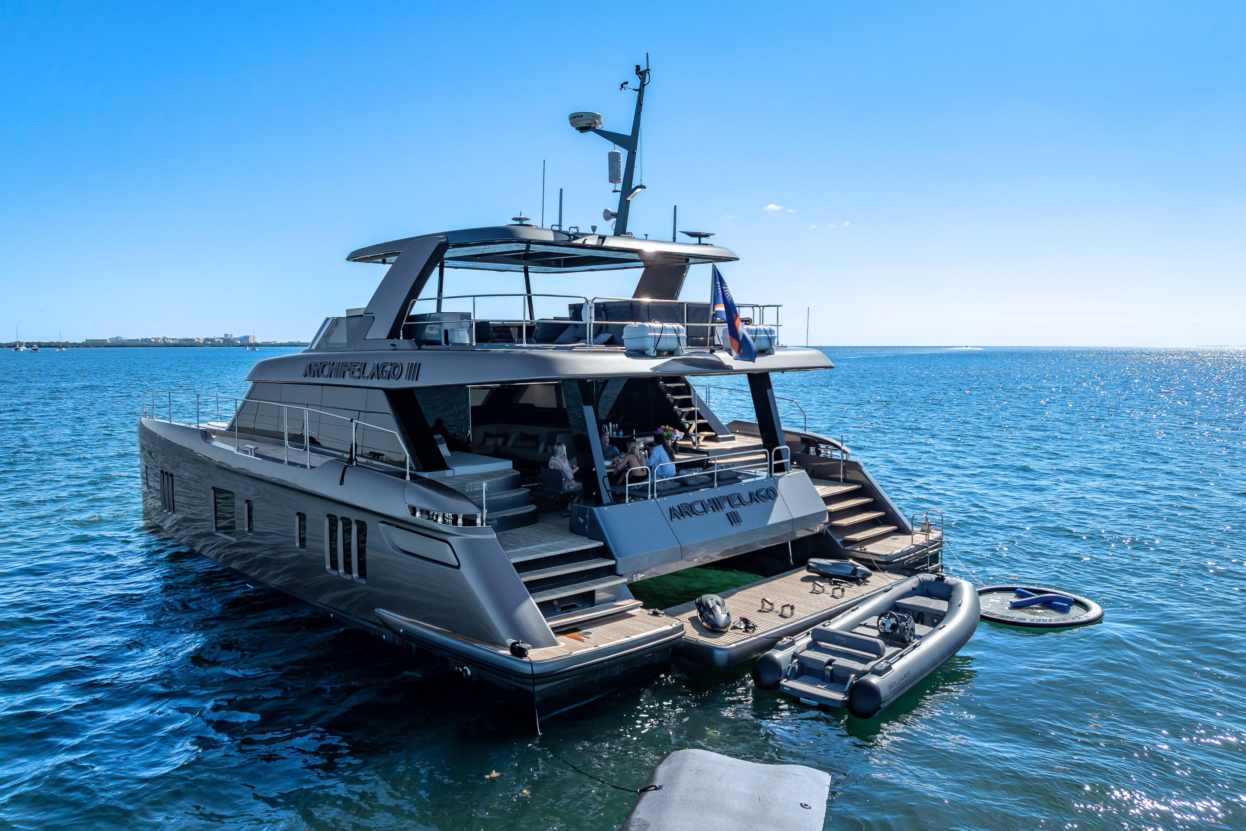 Luxurious 2026 Sunreef 60 Power yacht docked on serene blue waters.