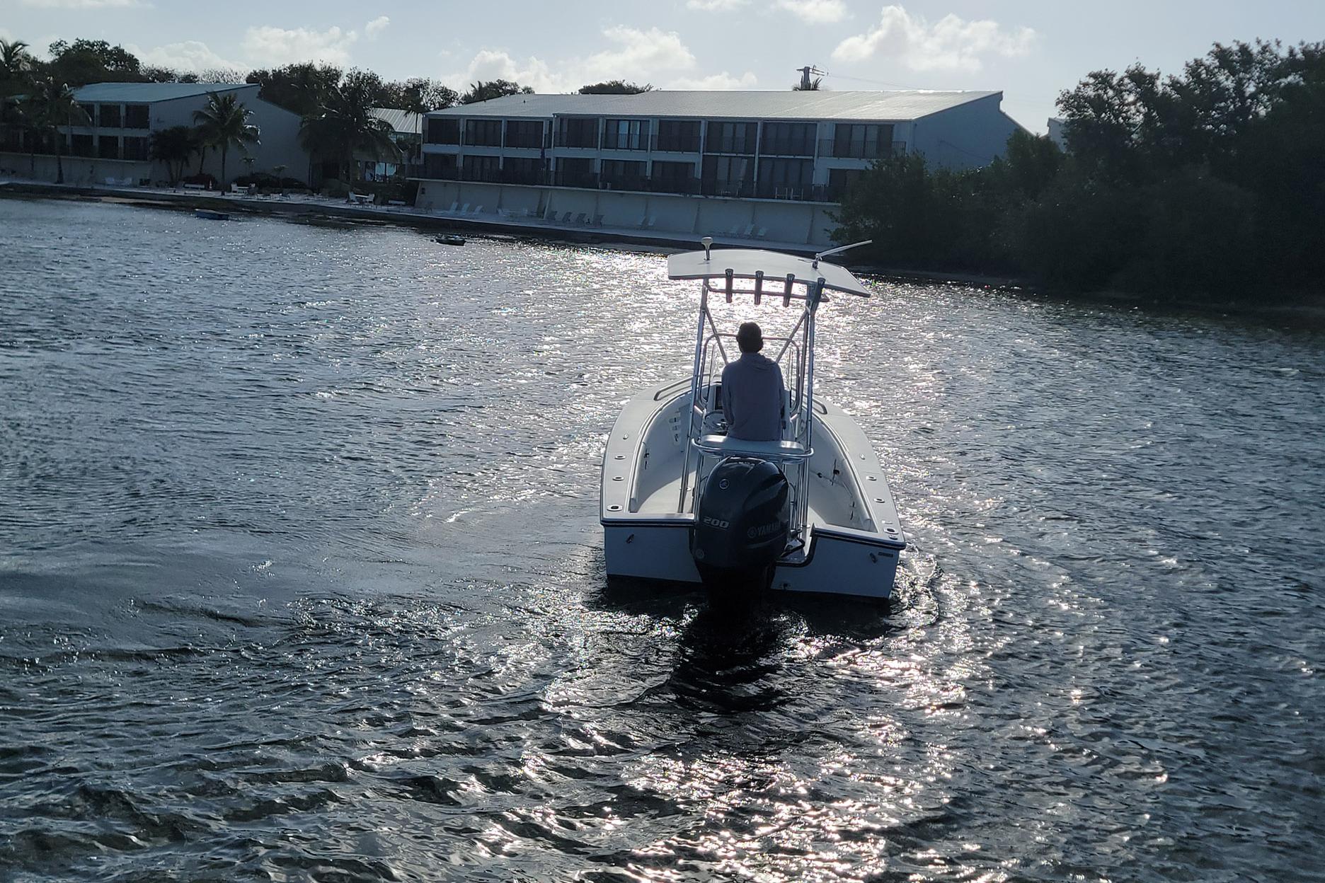 2008 SeaCraft SC 20 Classic boat cruising on a sunny waterfront.