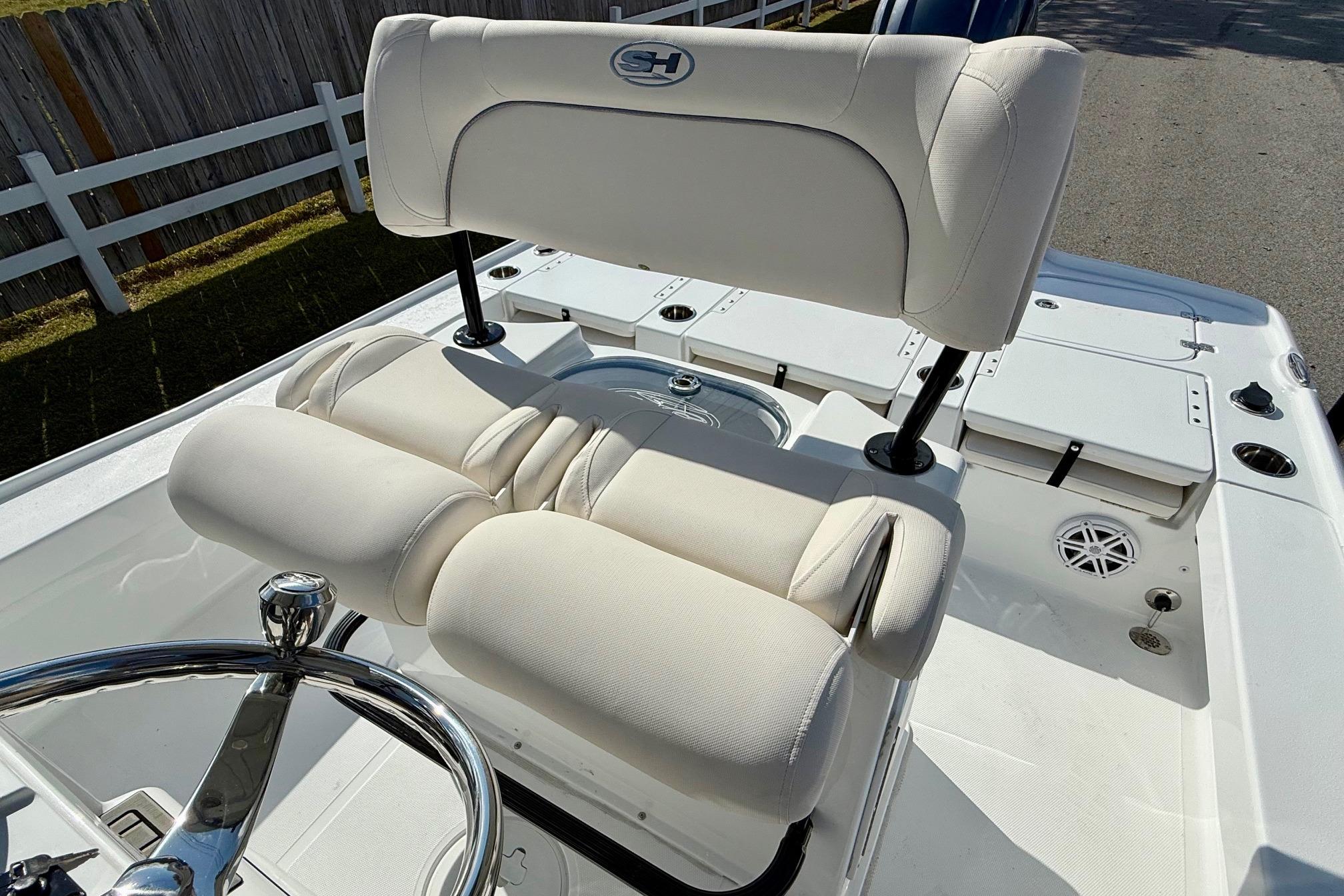 2026 Sea Hunt BX 22 BR boat interior with white cushioned seating and steering wheel.