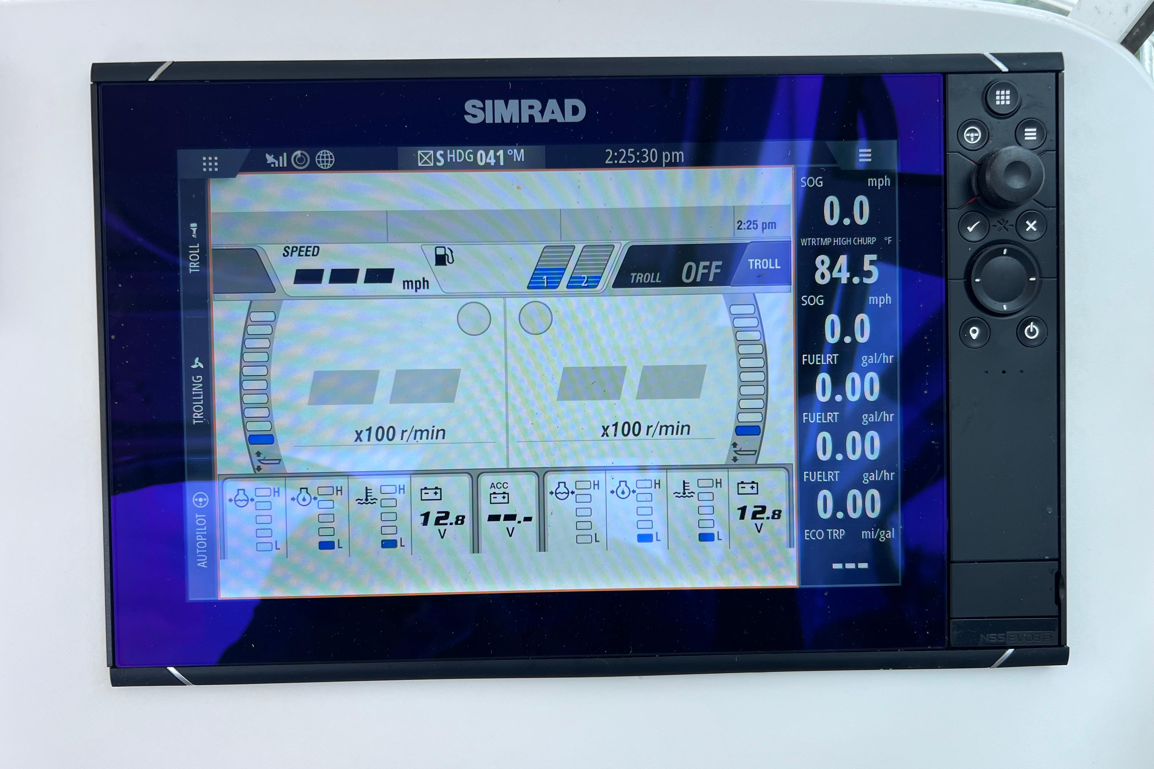 Simrad marine display on 2005 Pursuit 3070 Offshore, showing speed and fuel metrics.