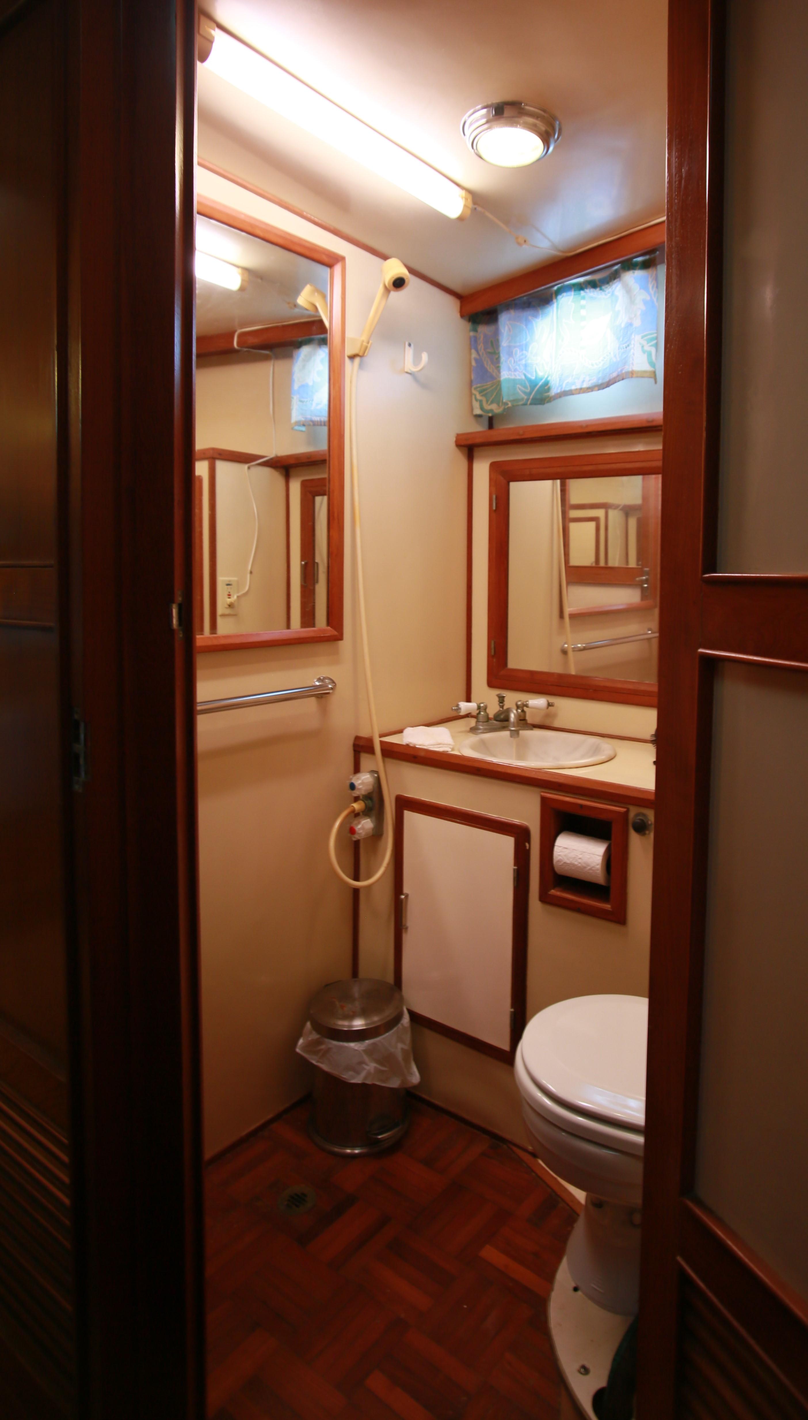 1987 Jefferson 42 Sundeck Motor Yacht bathroom with wooden accents and compact design.