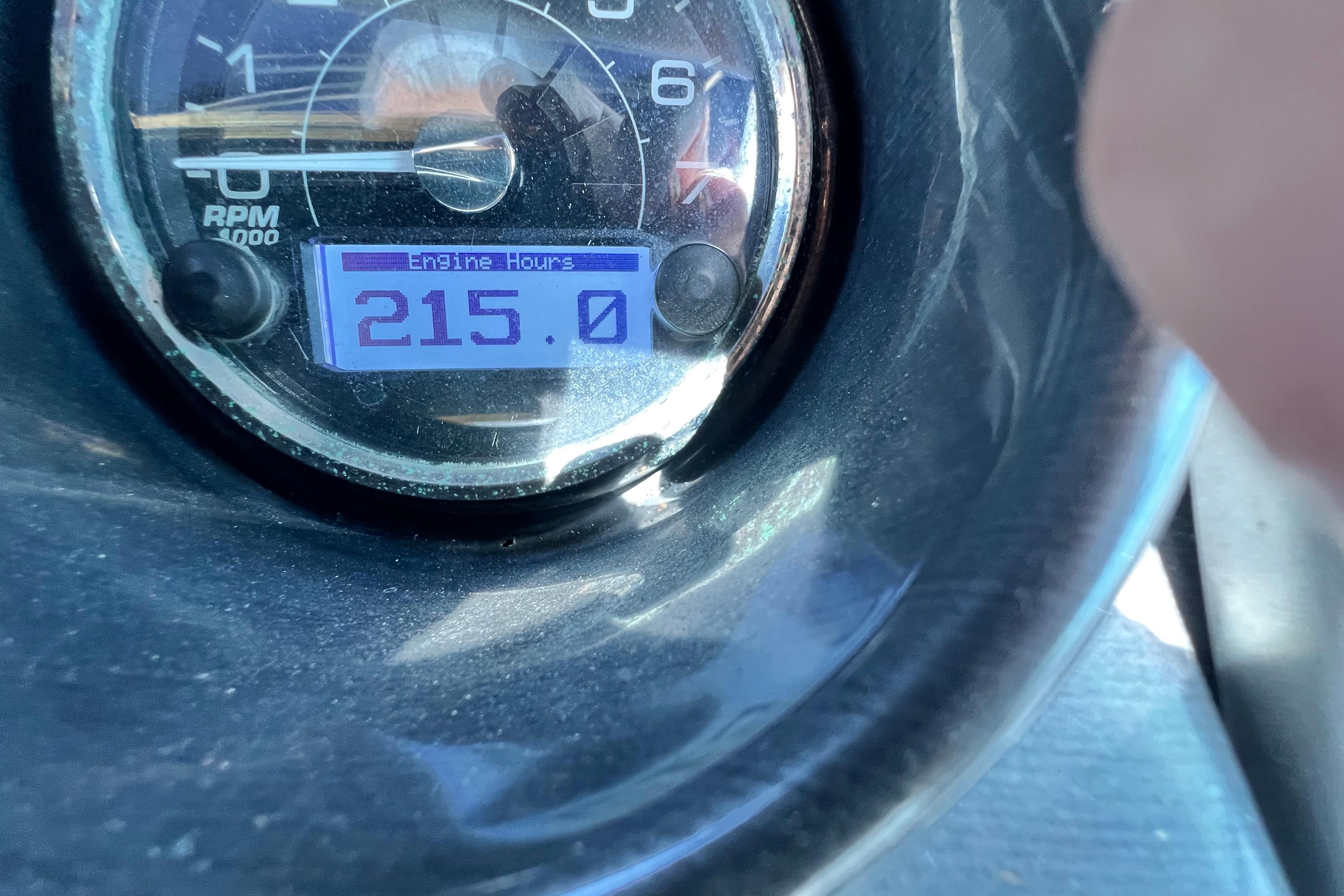 Close-up of a 2015 Monterey 268SS Super Sport engine hour meter showing 215 hours.