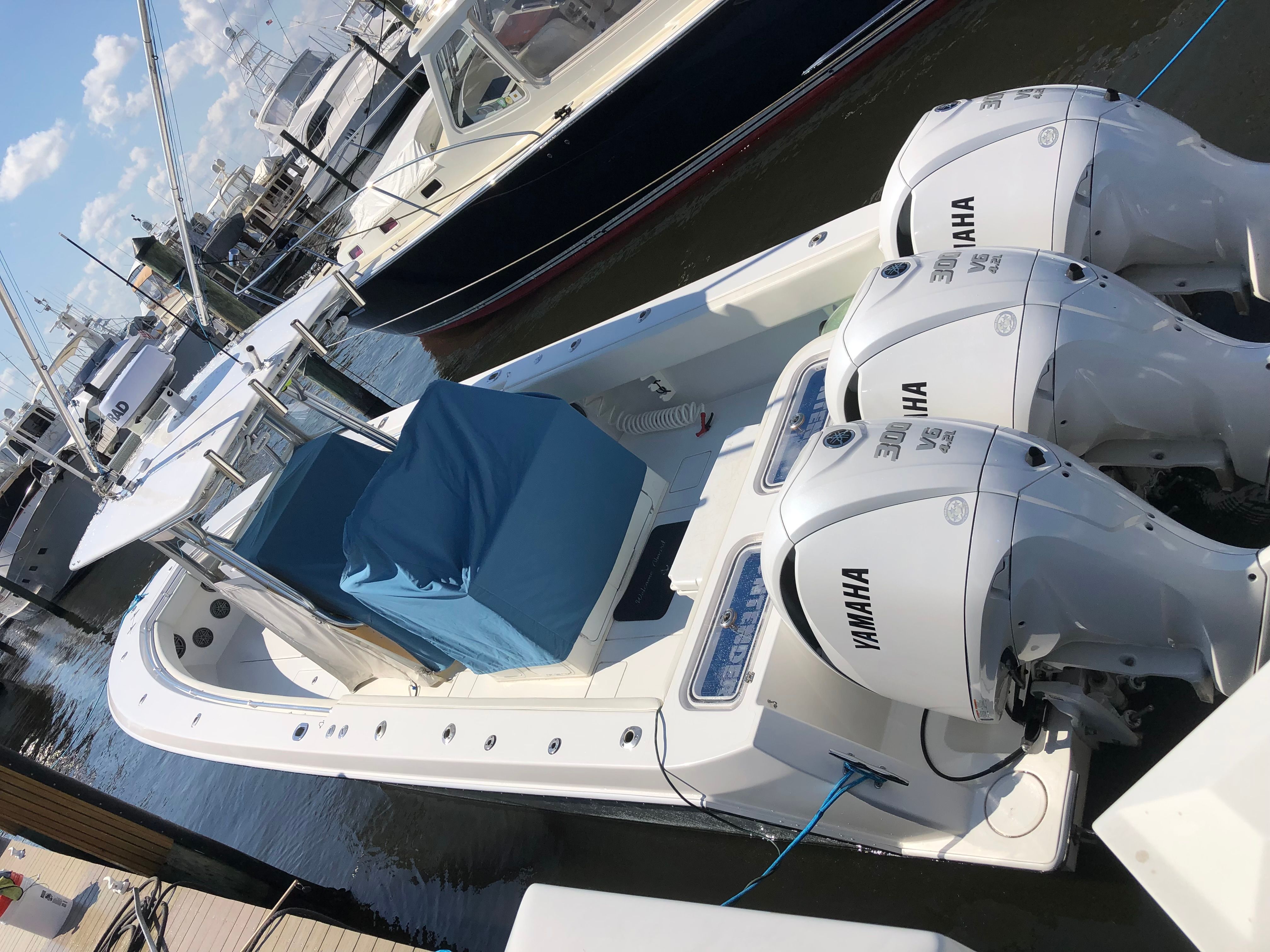 2009 Contender 33 Tournament boat with Yamaha engines docked.