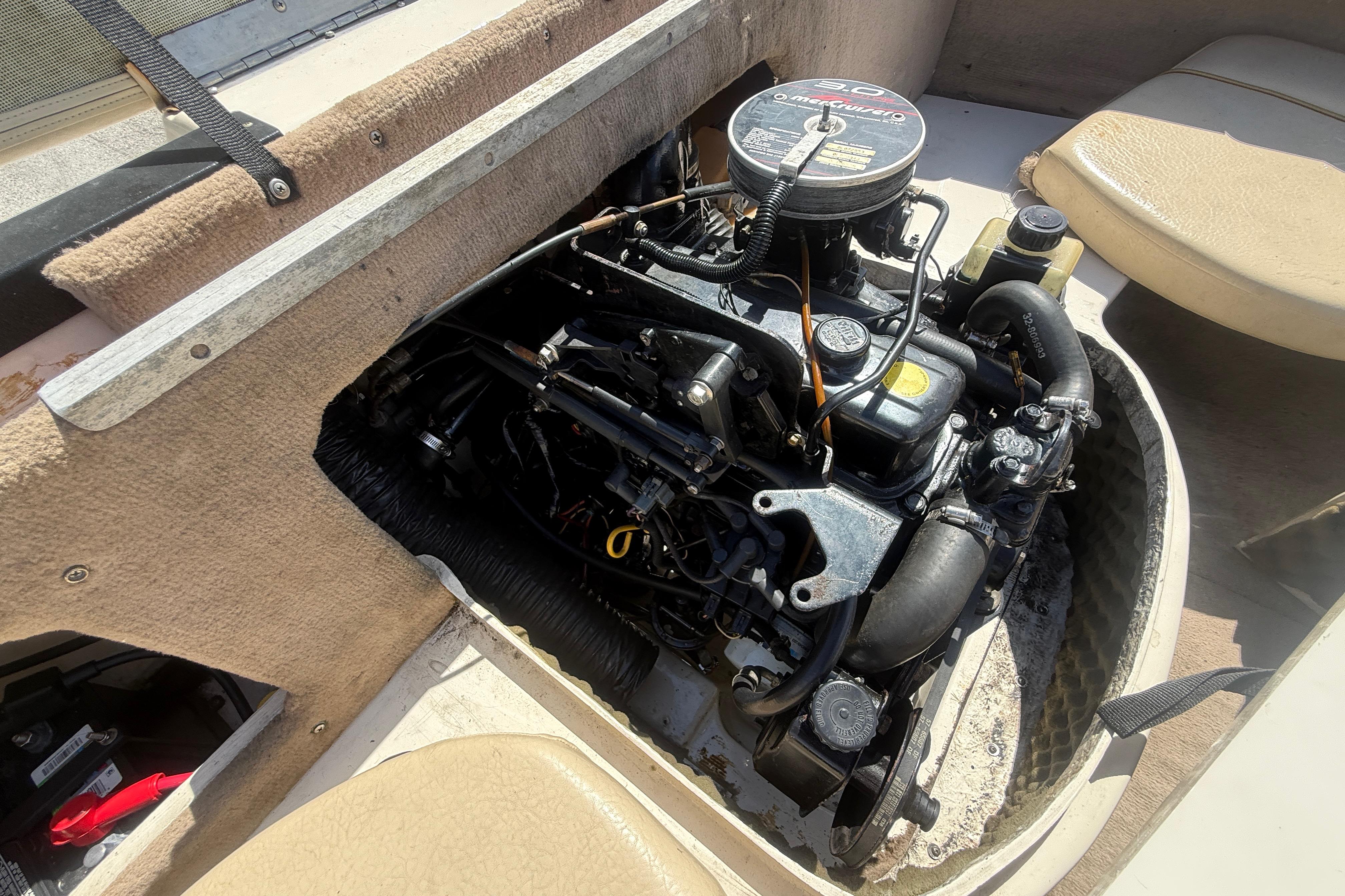 Engine compartment of a 2001 Sea Ray 180 Bow Rider boat, showcasing the motor.