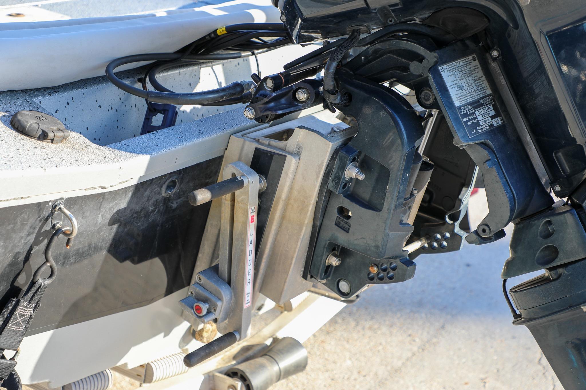 Close-up of a 2019 Express 18 boat motor mount and ladder mechanism.