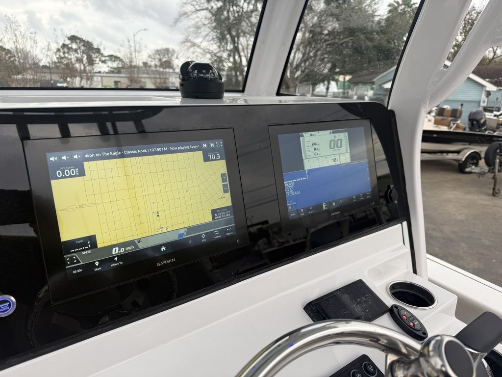 The image shows the dashboard of a Sportsman Masters 247OE Bay Boat with modern navigation screens.