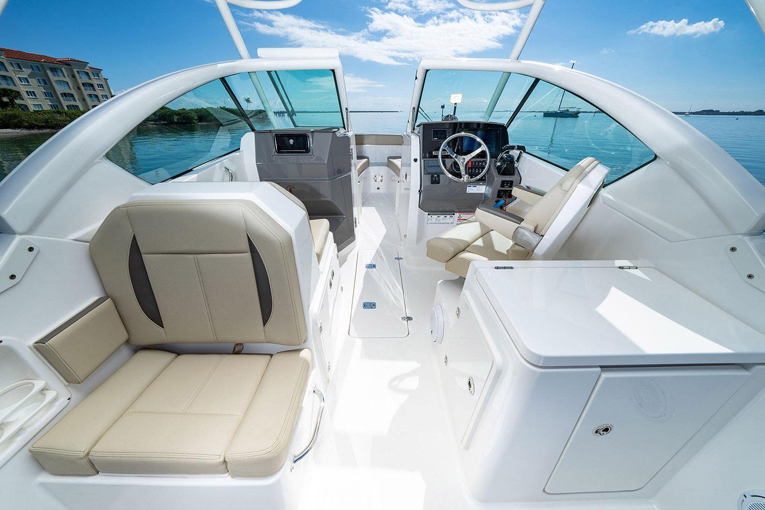 Manufacturer Provided Image: 2025 Pursuit DC 266 Dual Console boat interior with beige seating and modern dashboard.