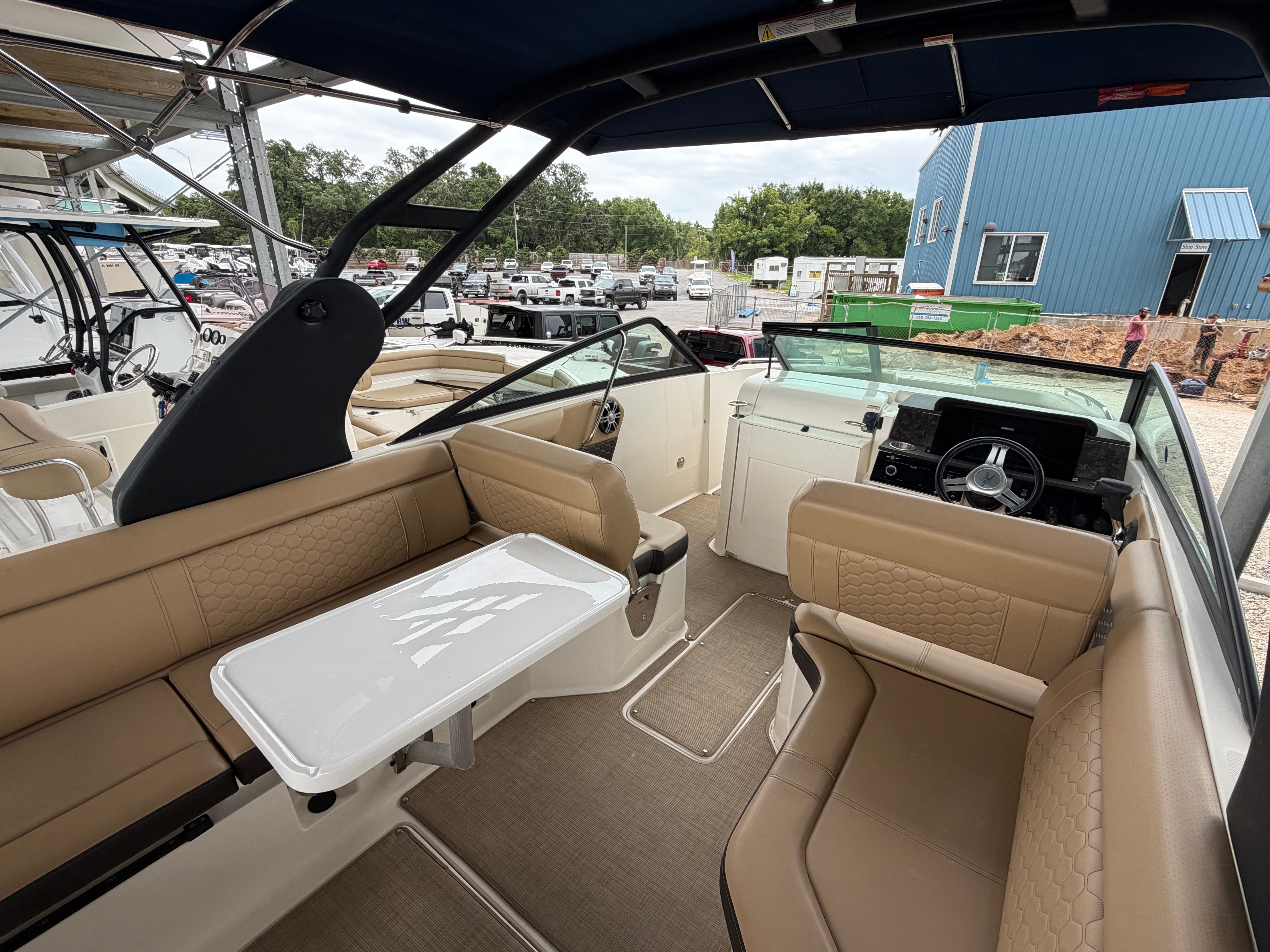 Interior of a 2020 Sea Ray SDX 250 Outboard boat with beige seating.