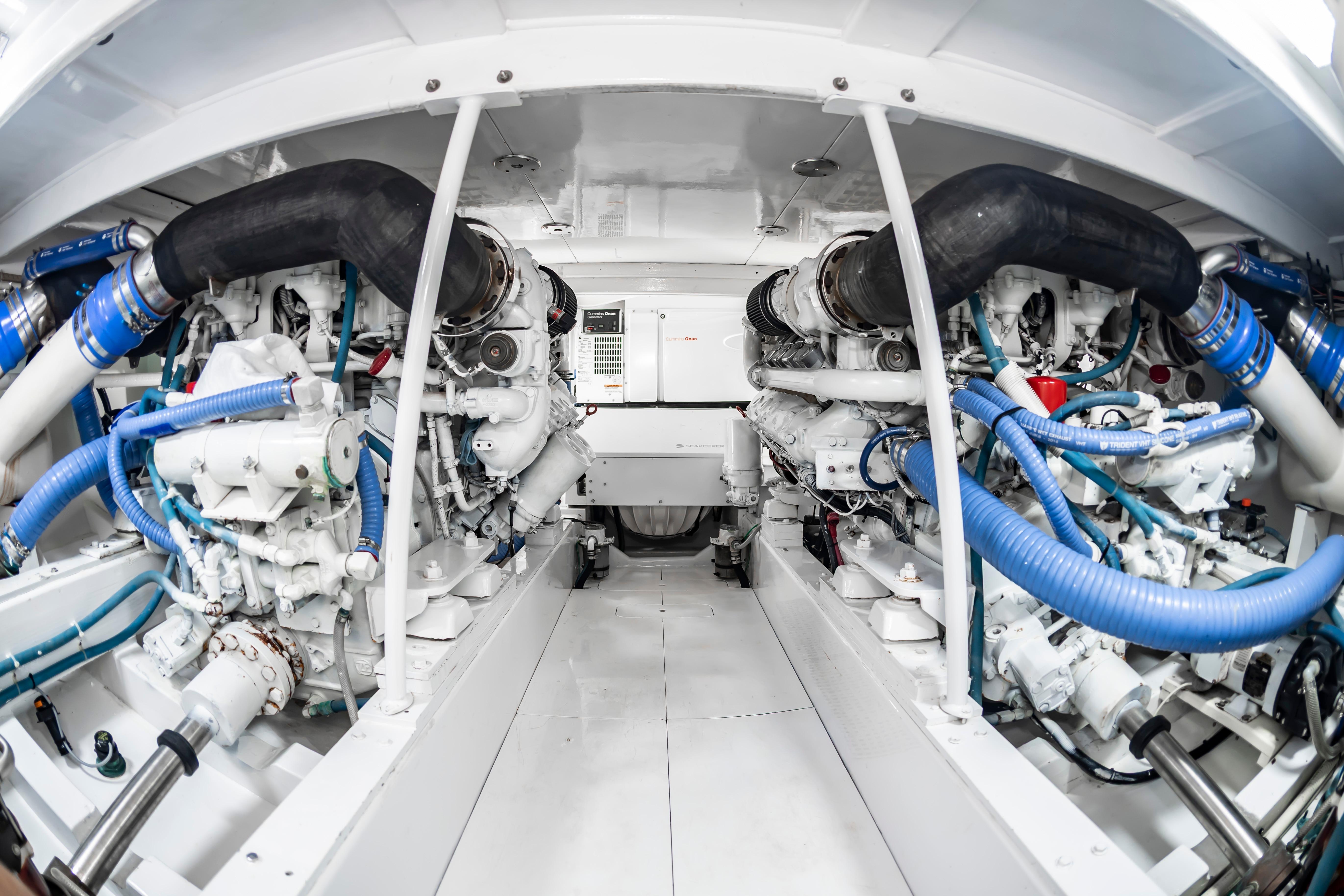 Engine room of 1993 Custom Carolina Scarborough 56 Convertible yacht, showcasing dual engines and piping.