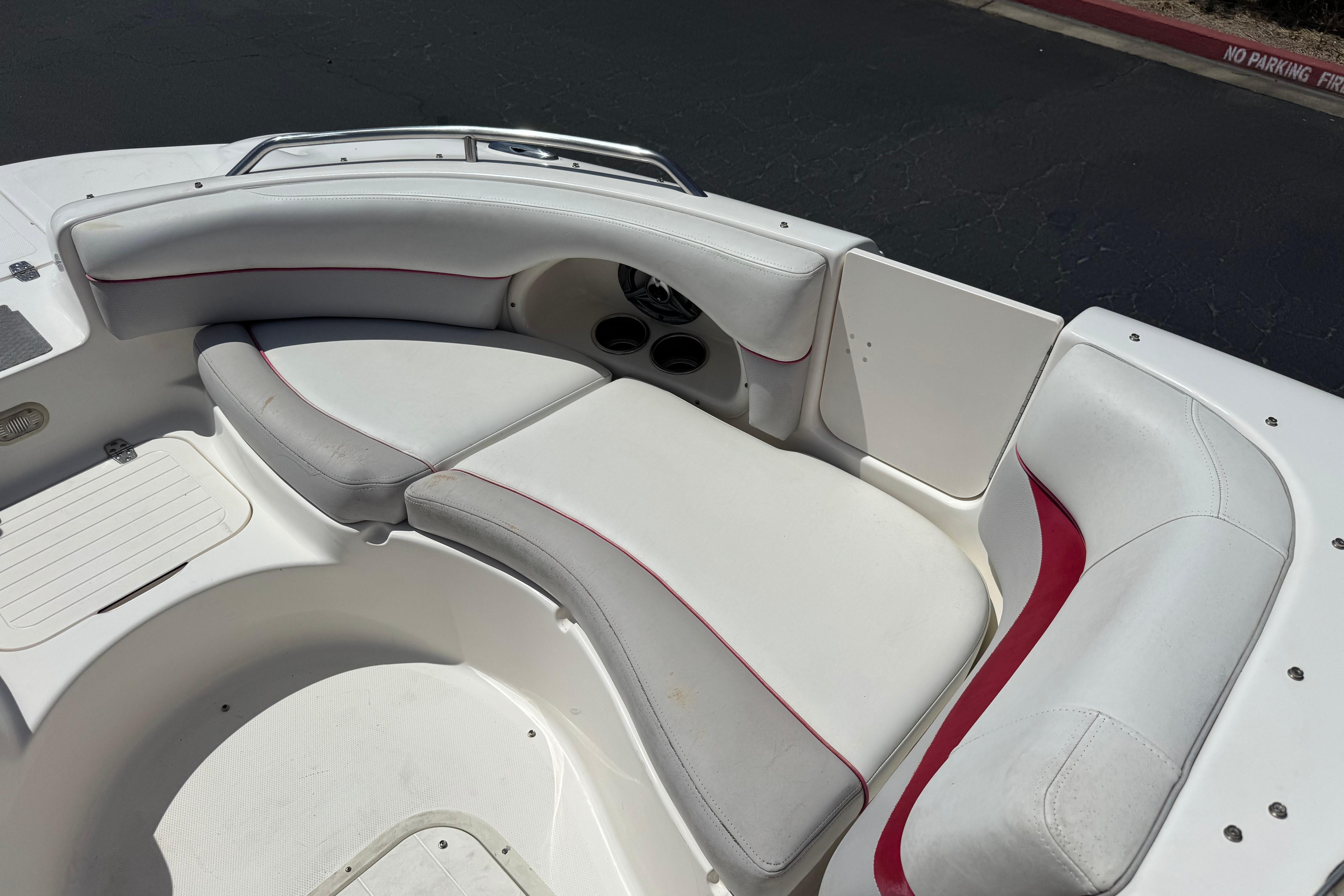 2010 Bryant 255 boat interior with white and red cushioned seating.