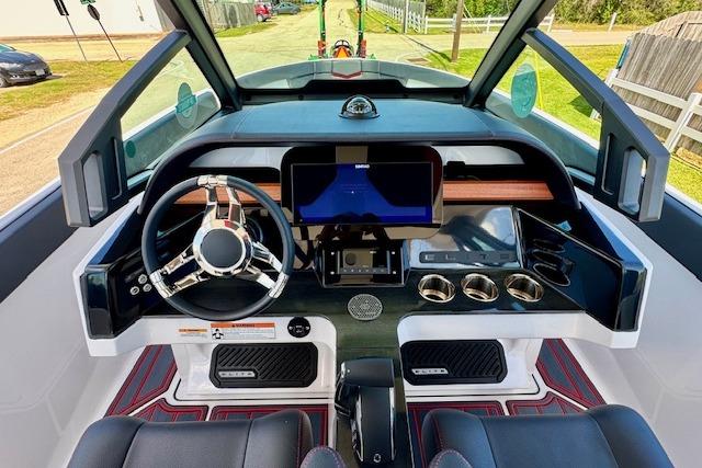 Cockpit of 2026 Monterey Elite 25 OB boat with modern steering and digital display.
