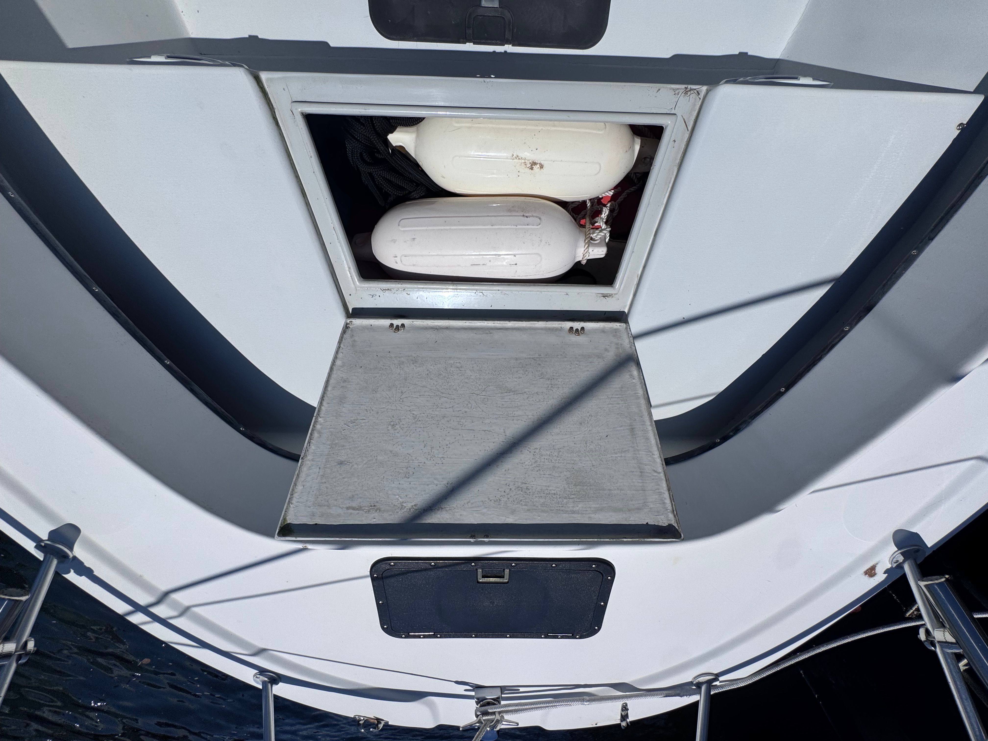 Storage compartment on a 1998 Dusky 20.3 boat with life buoys.