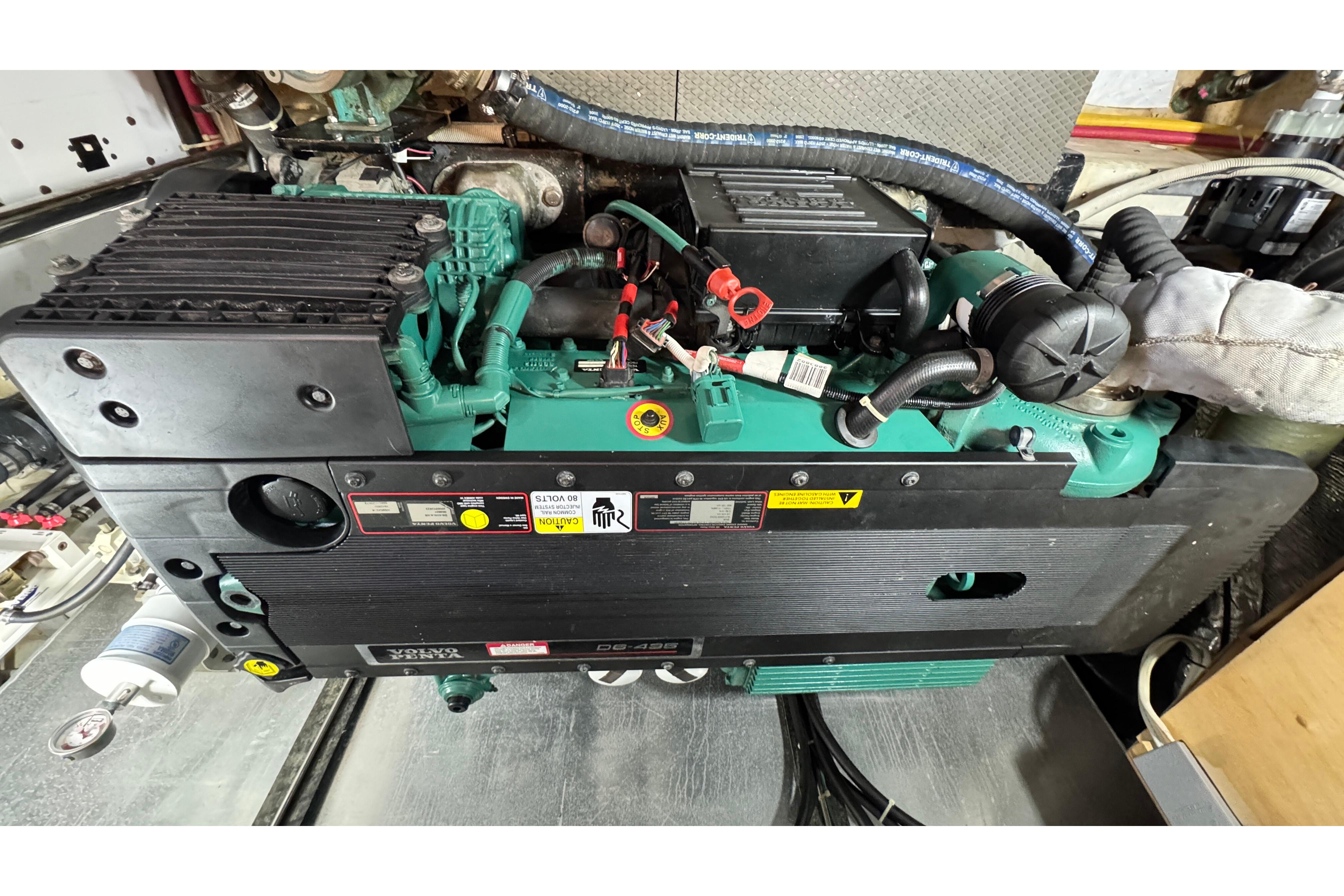 Engine of a 2007 Carver 47 Motor Yacht, showcasing detailed components and wiring.