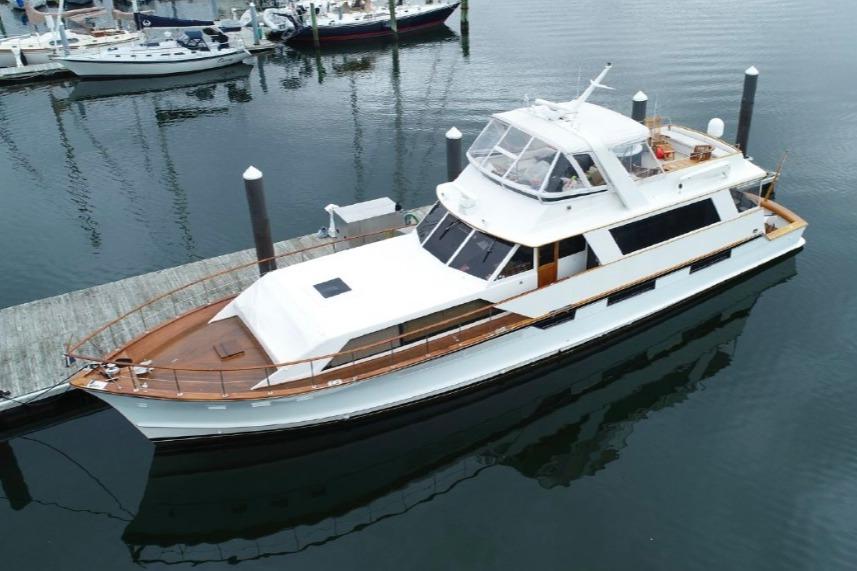 1974 Pacemaker Cockpit Motoryacht docked at marina, featuring classic design and spacious deck.