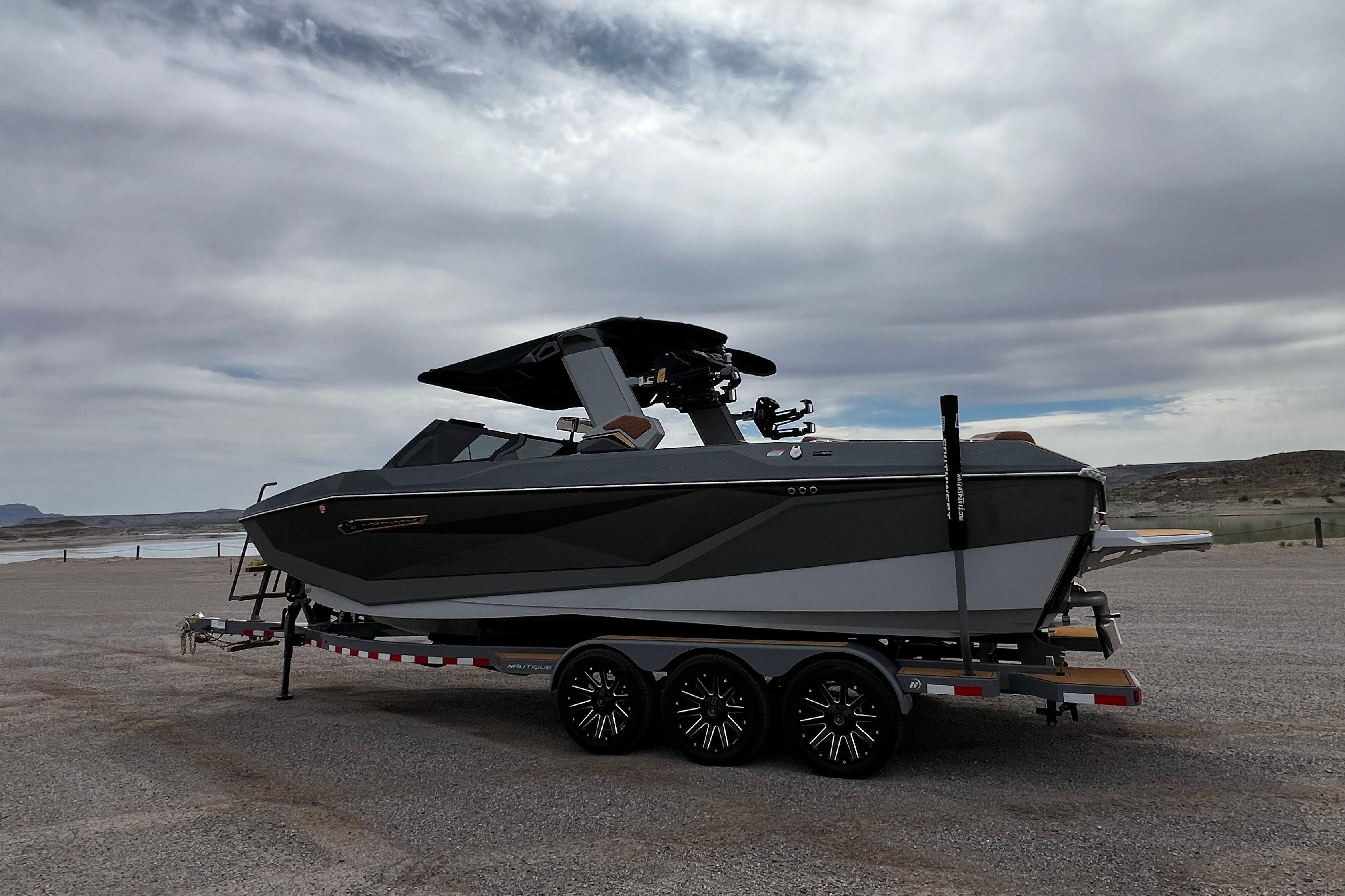 2026 Nautique Super Air Nautique G25 boat on trailer under cloudy sky.