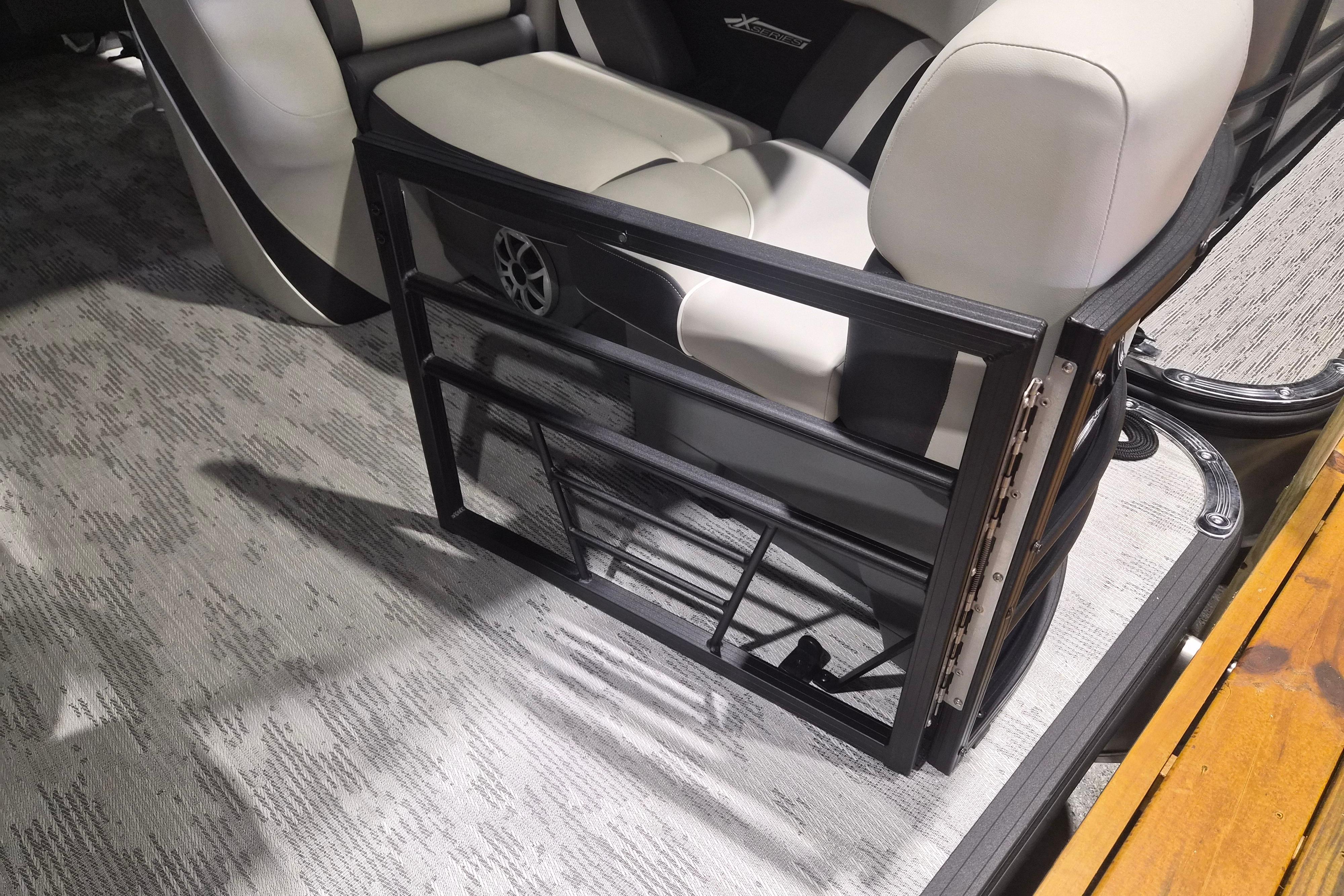 2026 Sylvan R-22 LZ DH boat interior with foldable gate and cushioned seating.