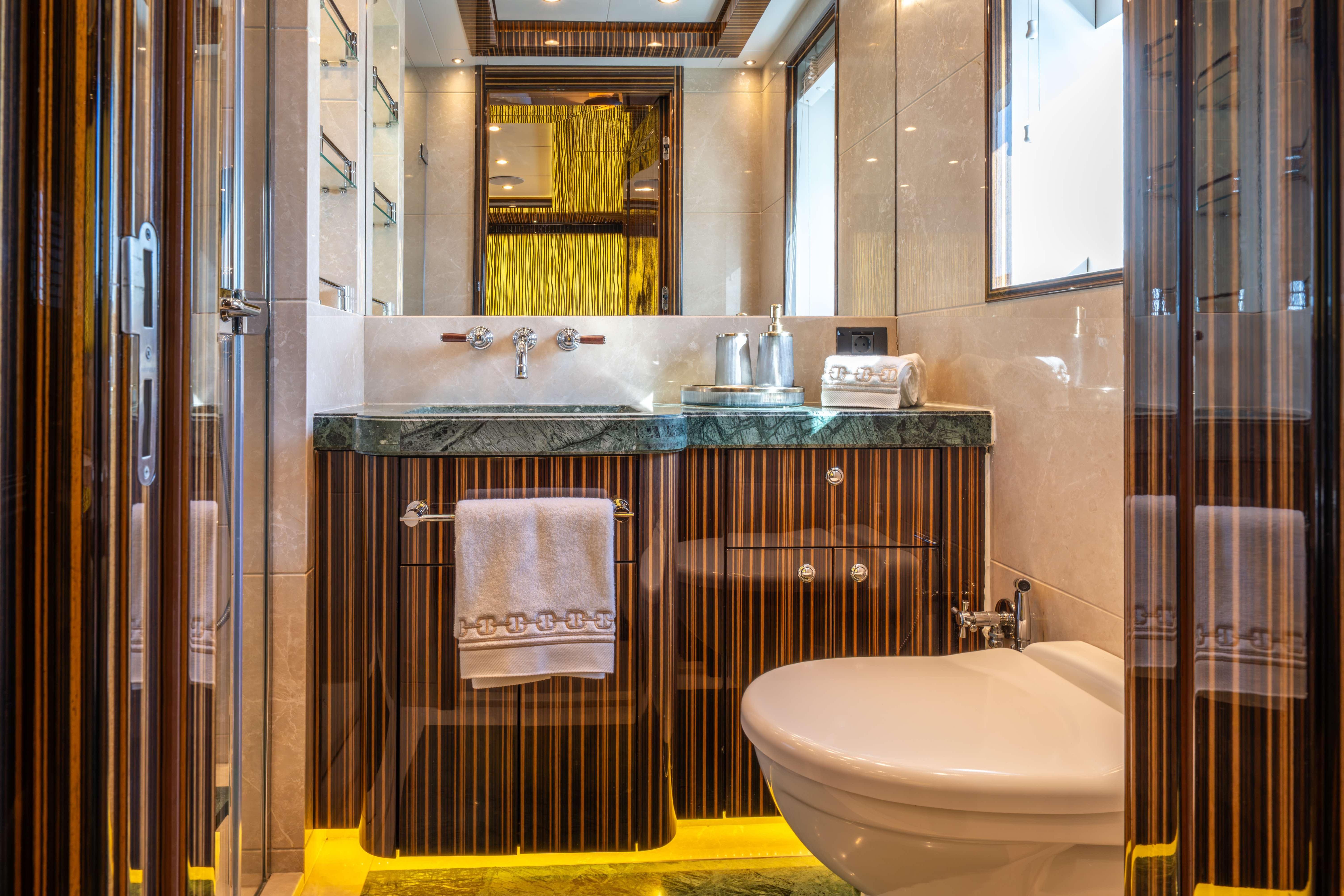 Luxurious bathroom in 2014 Bilgin 147 yacht with elegant wood and marble finishes.