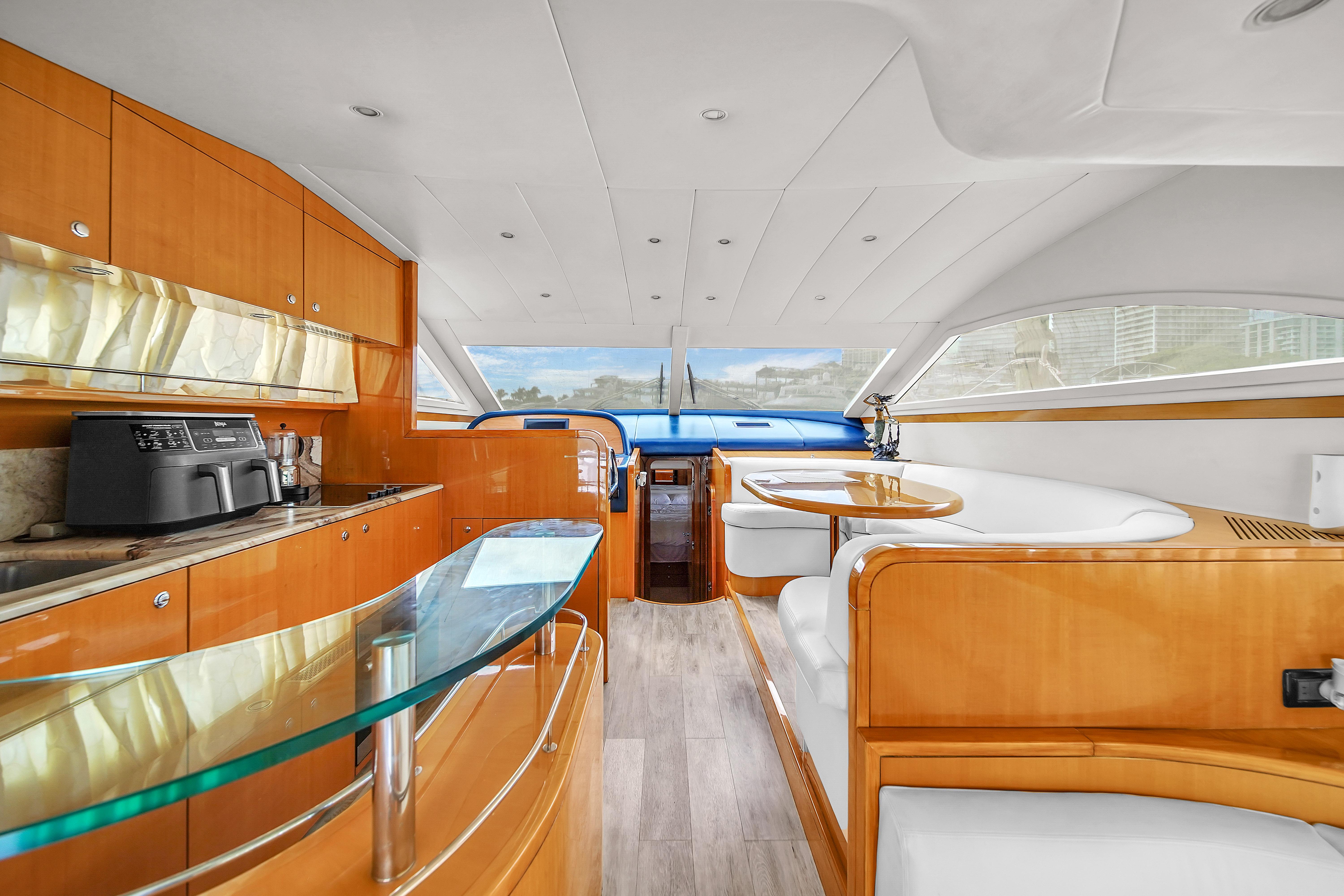 Interior of 2006 Uniesse 58 yacht with modern kitchen and dining area.