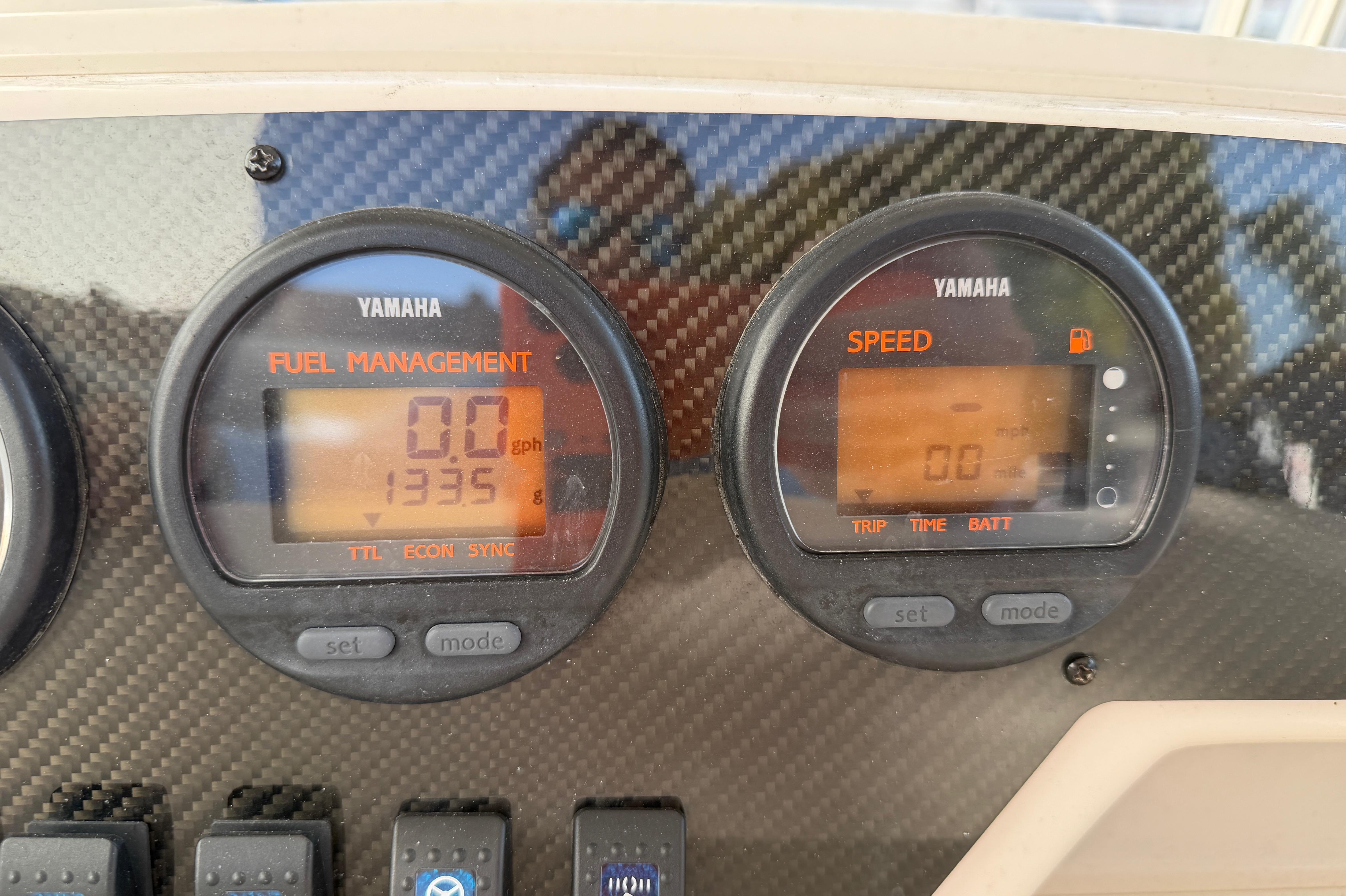 Yamaha fuel management and speed gauges on 2004 Grady White 273 boat dashboard.