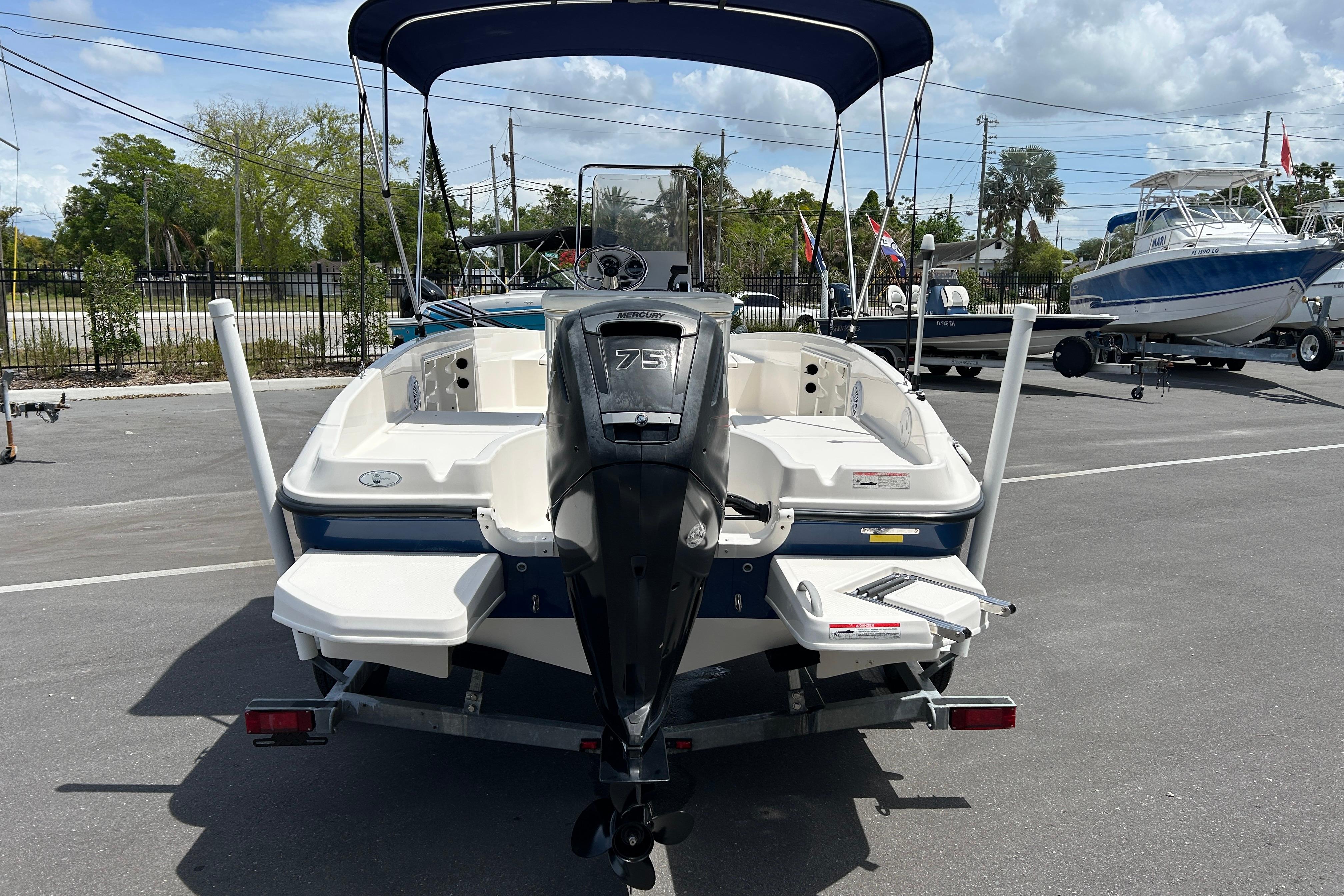 2018 Bayliner Element F16 boat with Mercury 75 engine, parked outdoors.