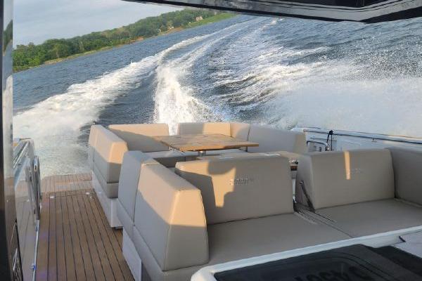 2023 Fjord 41 XL yacht cruising on a scenic waterway, featuring luxurious seating.