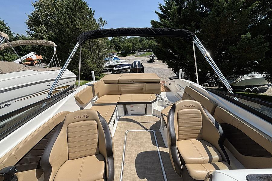 2019 Sea Ray SPX 230 Outboard boat interior with tan seating and canopy.