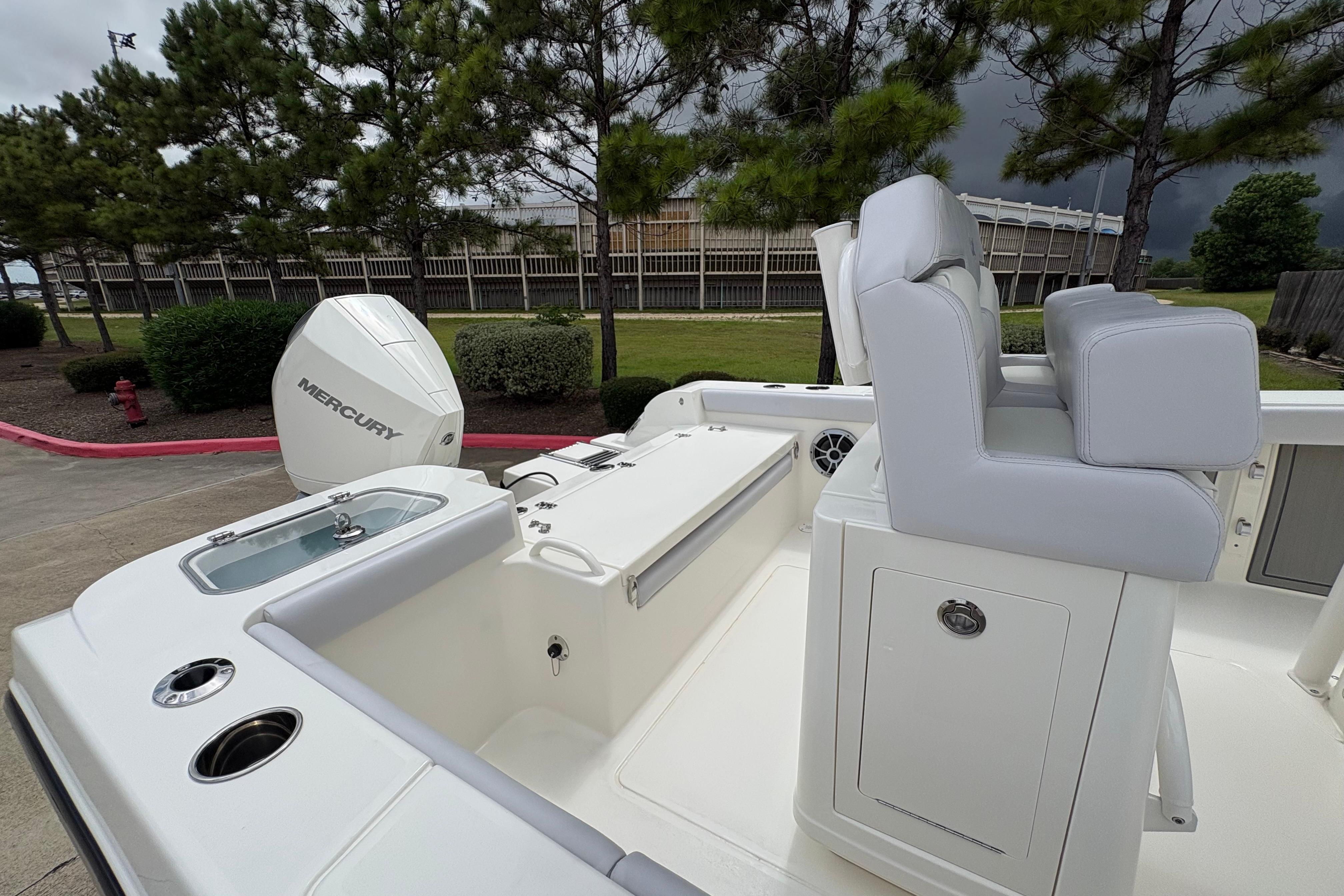 2026 Mako 226 Center Console boat with Mercury engine, white seating, and sleek design.