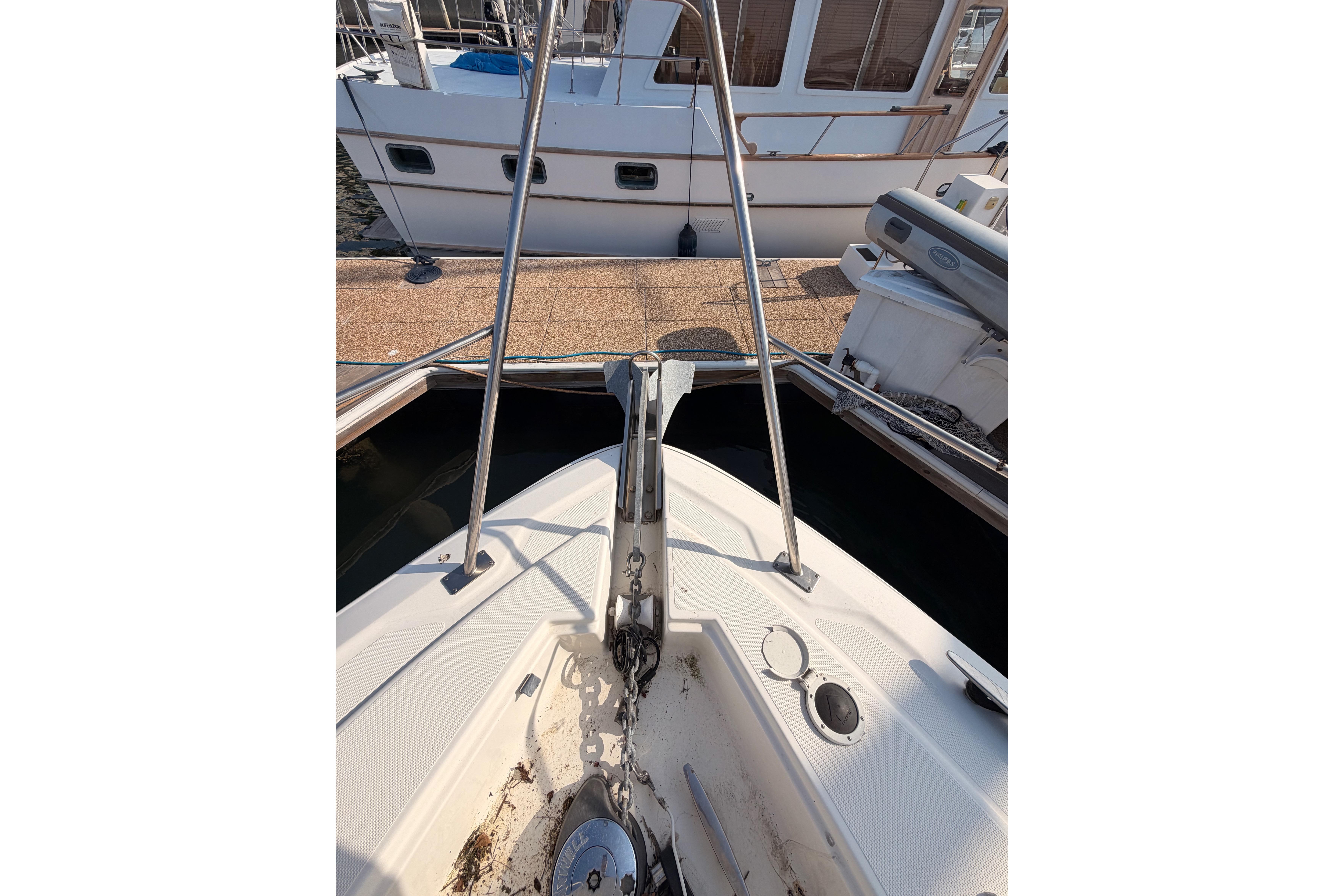2005 Cruisers Yachts 405 Express Motoryacht bow with anchor and dock view.