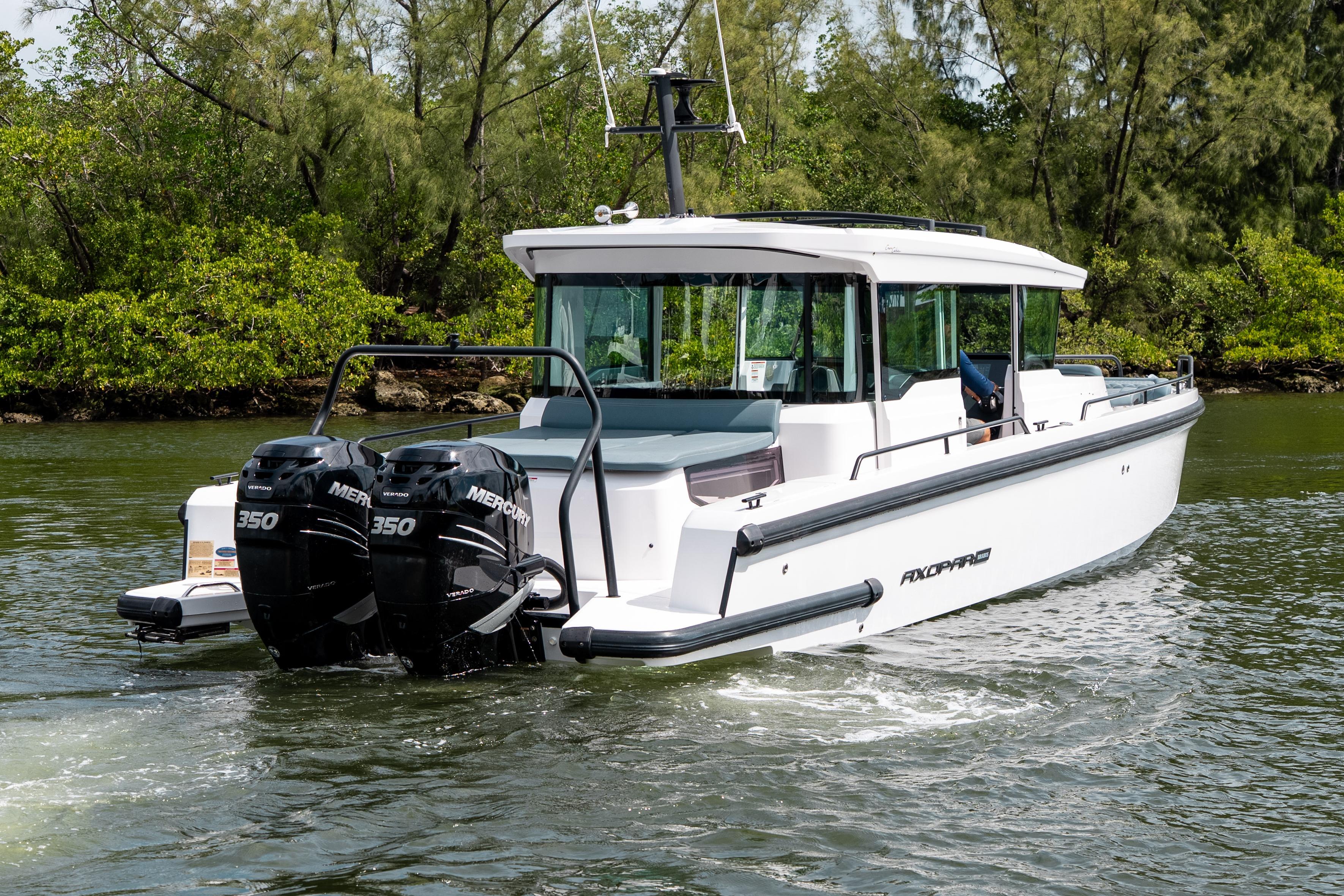 2022 Axopar 37 XC Cross Cabin boat cruising on a scenic waterway.