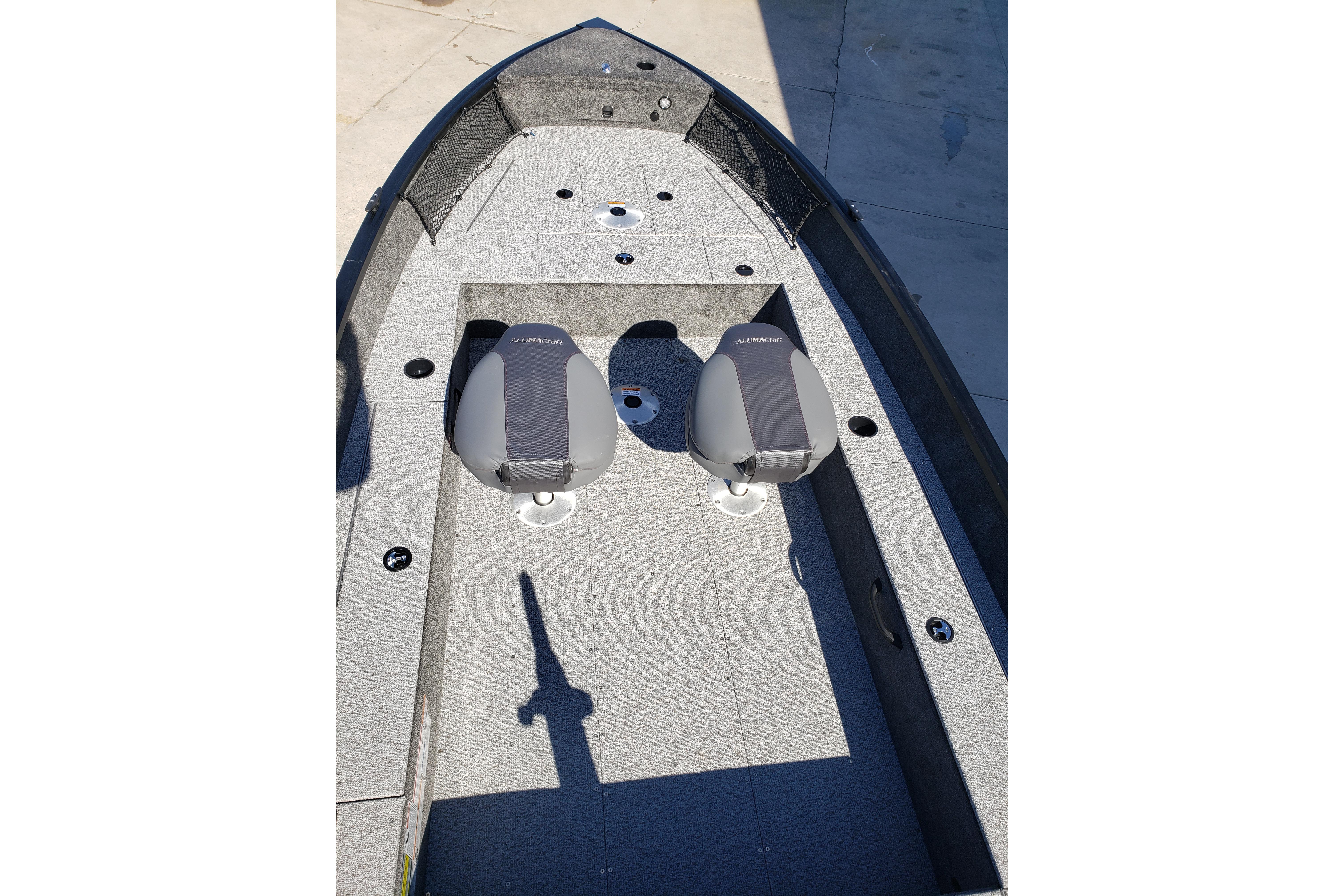 2026 Alumacraft Classic 165 Tiller boat interior with two seats and gray flooring.
