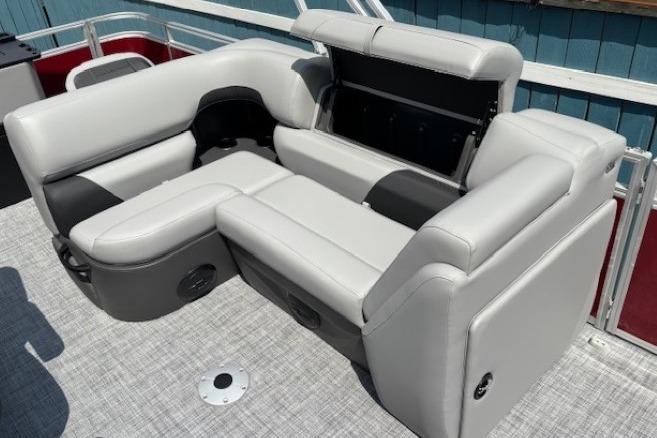 2026 Sun Tracker SportFish 20 DLX pontoon boat with gray seating and storage compartment.