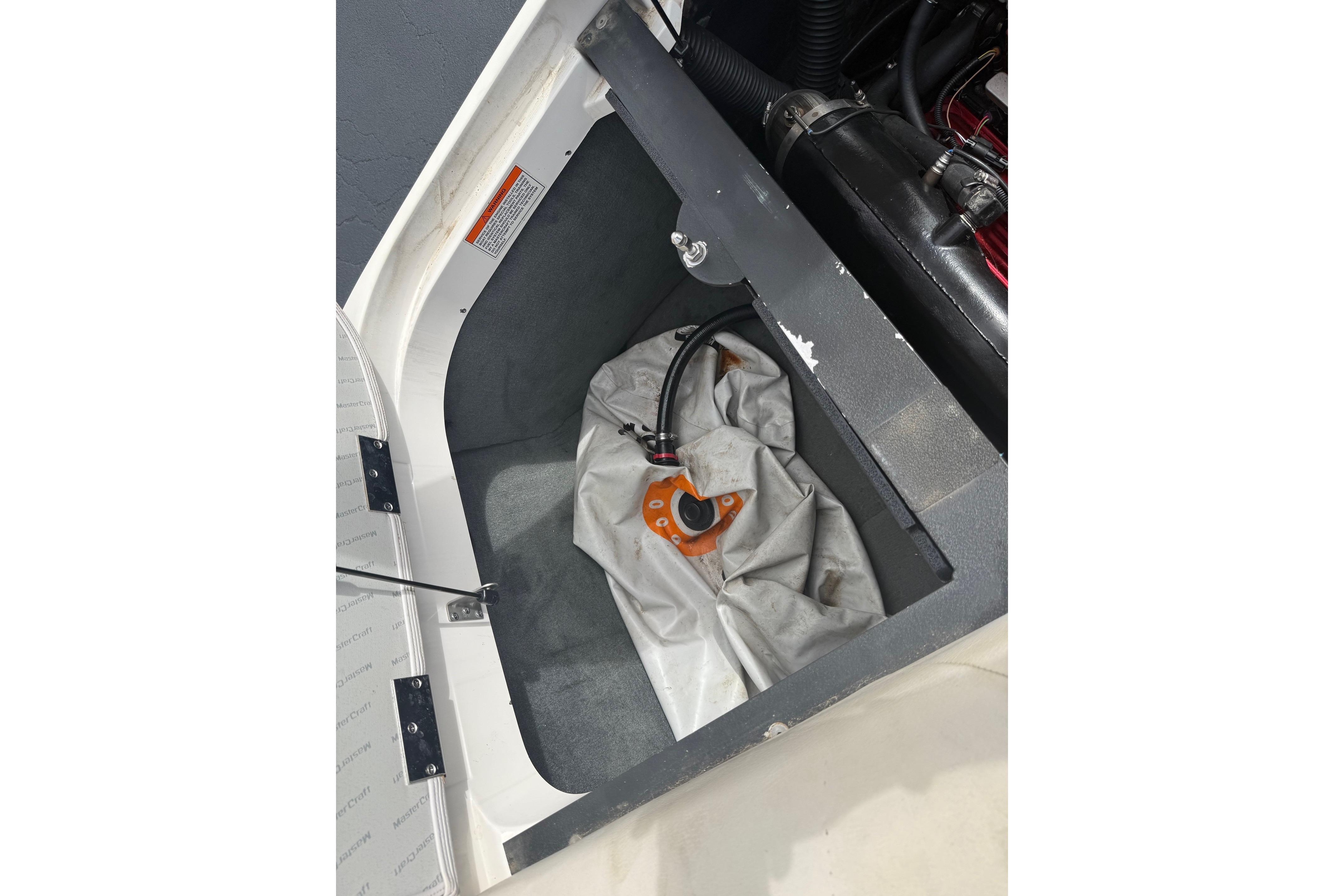 2008 MasterCraft X-15 storage compartment with equipment and wiring.