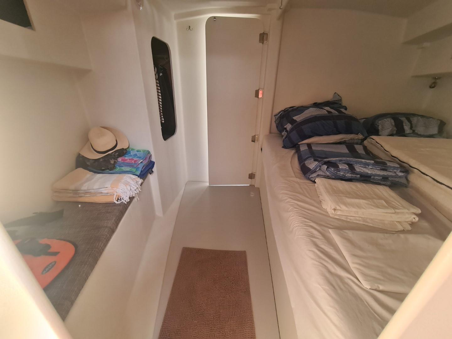 Cozy cabin interior of 2022 JPK JMP 39 yacht with neatly arranged bedding and essentials.