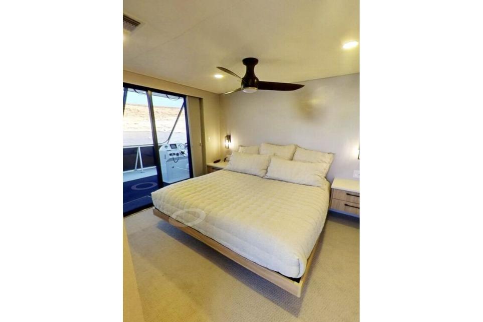 Modern bedroom on Adonia's Galileo Trip #1, featuring a cozy bed and scenic window view.